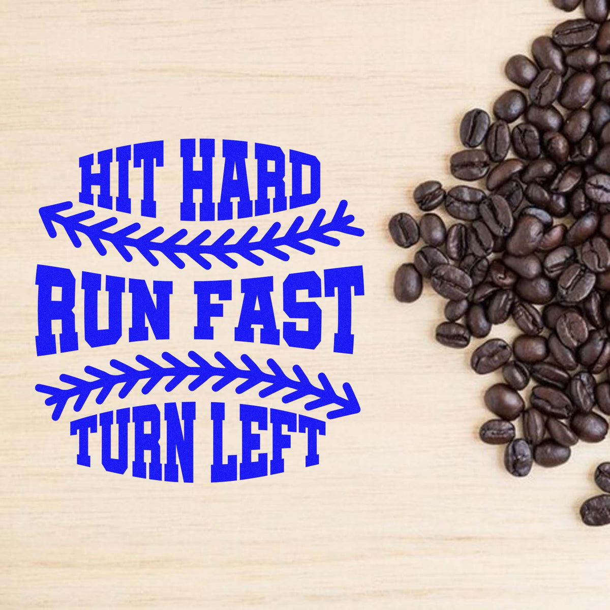 Blue HIT HARD RUN FAST TURN LEFT rubber stamp seal on wood background beside coffee beans
