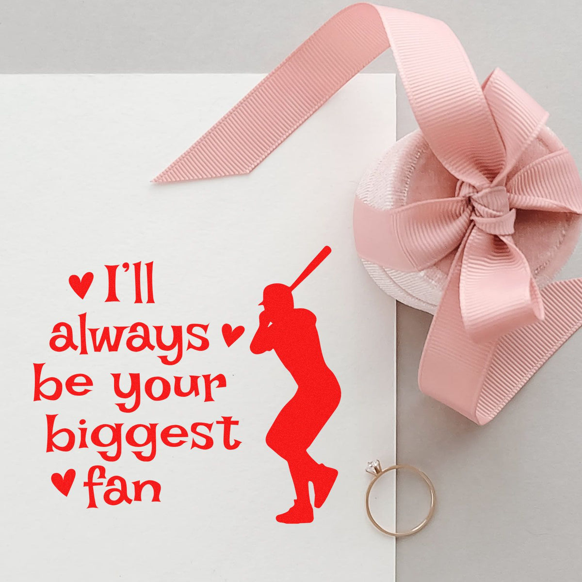 Pink ribbon-wrapped stamp and seal set with red custom quote and dancer silhouette on white packaging.