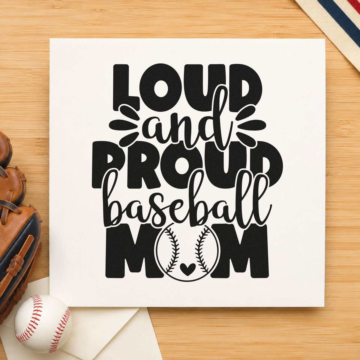 Proud Baseball Mom craft stamp imprint in black ink on a handmade project, one idea being scrapbook fan pages.