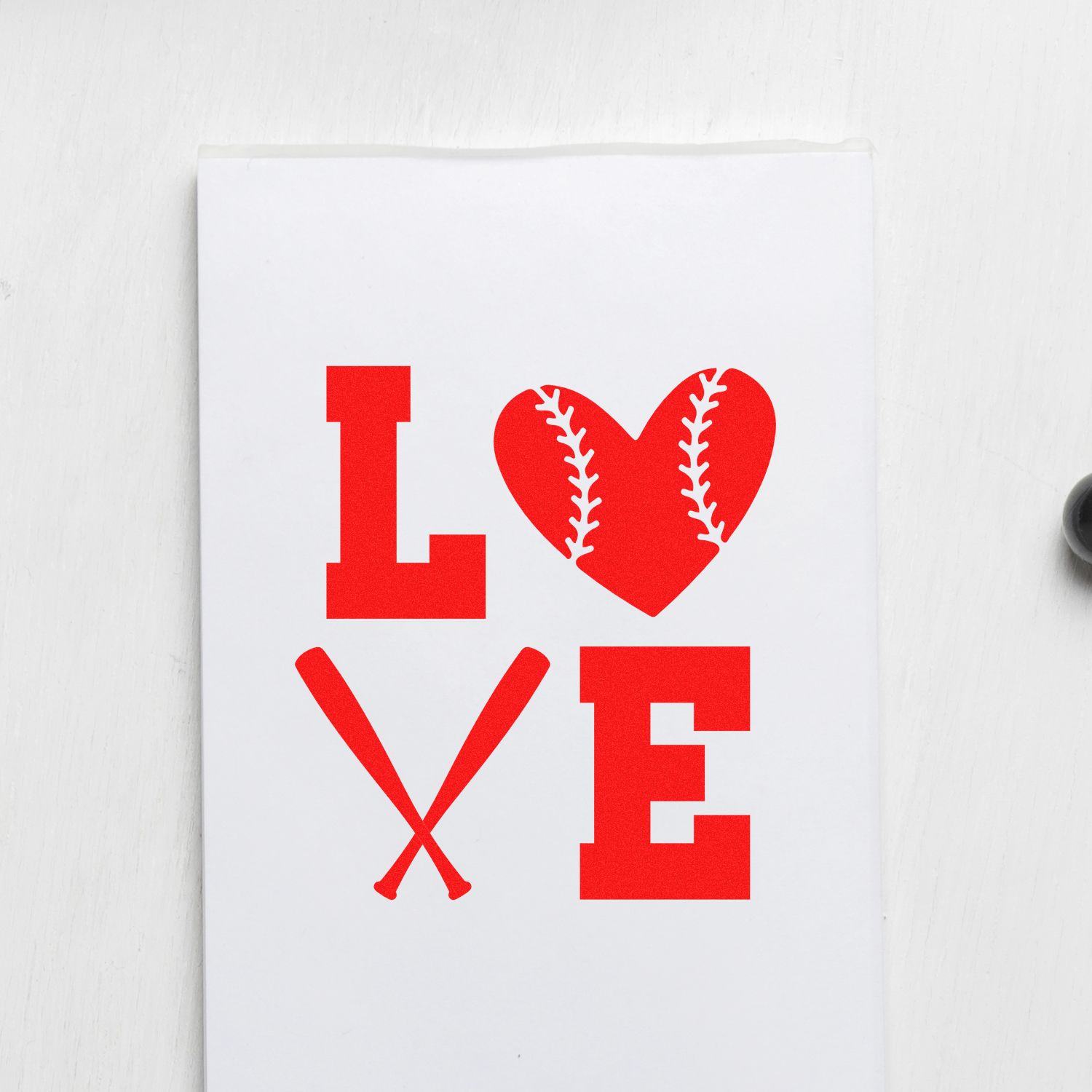 Red LOVE baseball stamp and seal design on white card, with heart-shaped ball, crossed bats, bold red letters