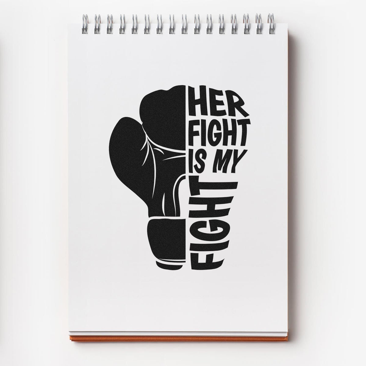 Black boxing glove graphic with Her Fight Is My Fight on white spiral notebook, shown as a stamp/seal design.