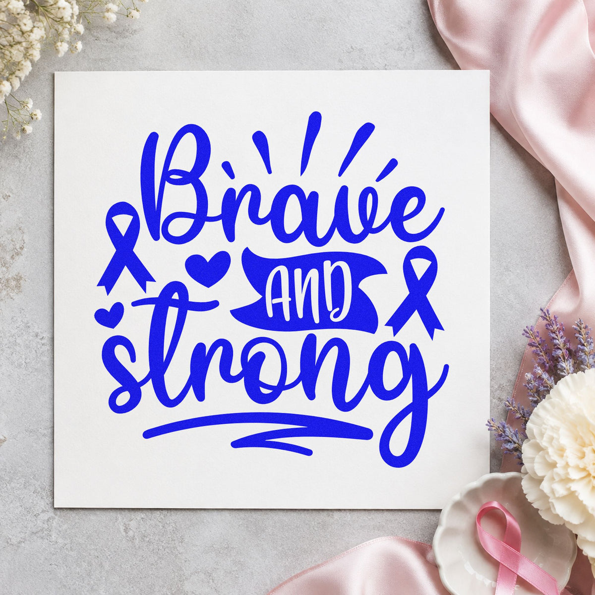 Brave and Strong Ribbons craft stamp imprinted in blue ink on paper, a design suited to bookmark gifts.