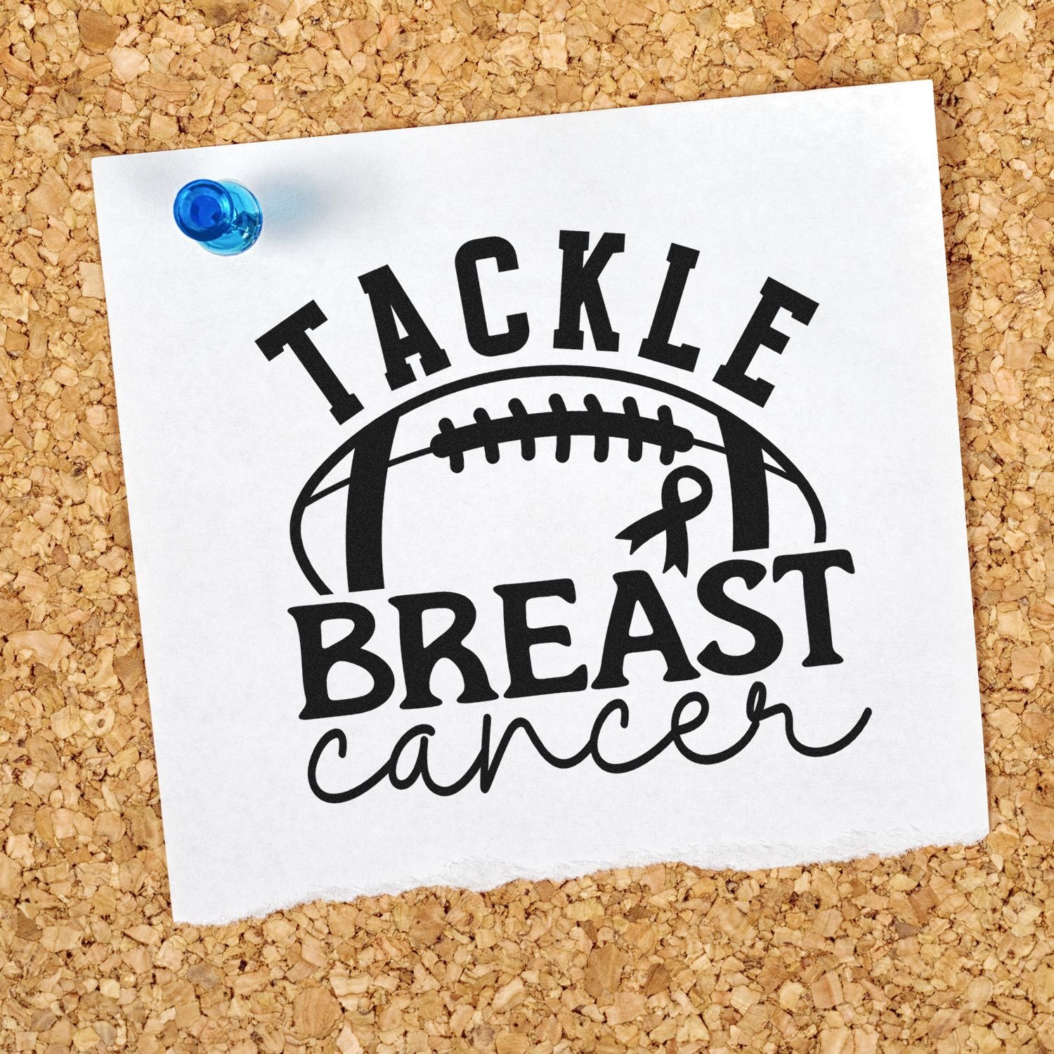 Blue-pinned white card on corkboard with black Tackle Breast Cancer football ribbon stamp design.