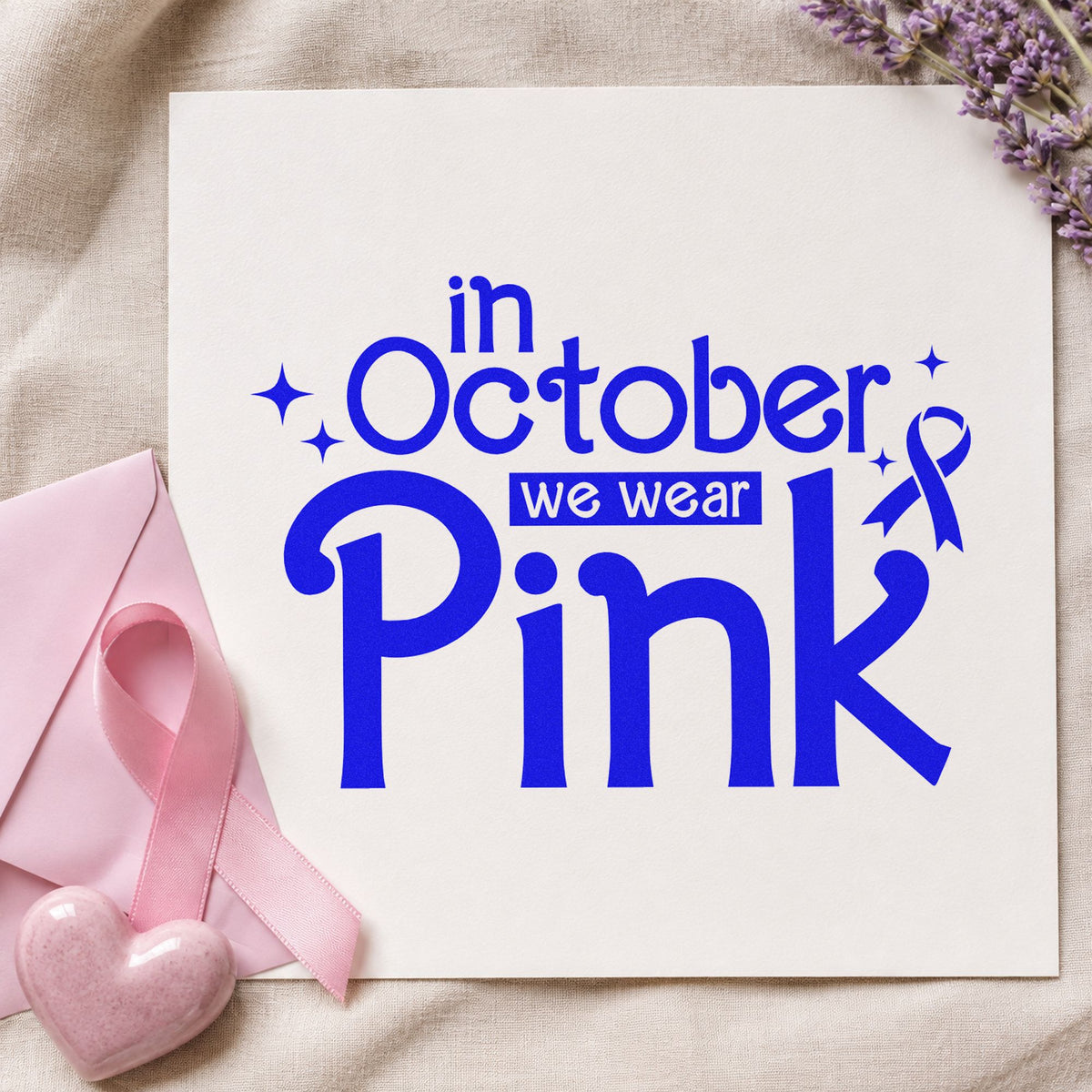 In October We Wear Pink craft stamp imprinted in blue ink on paper, a design suited to scrapbook october pages.