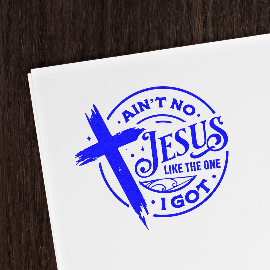 Blue ink stamp and seal design with cross and Aint No Jesus Like the One I Got on white paper.