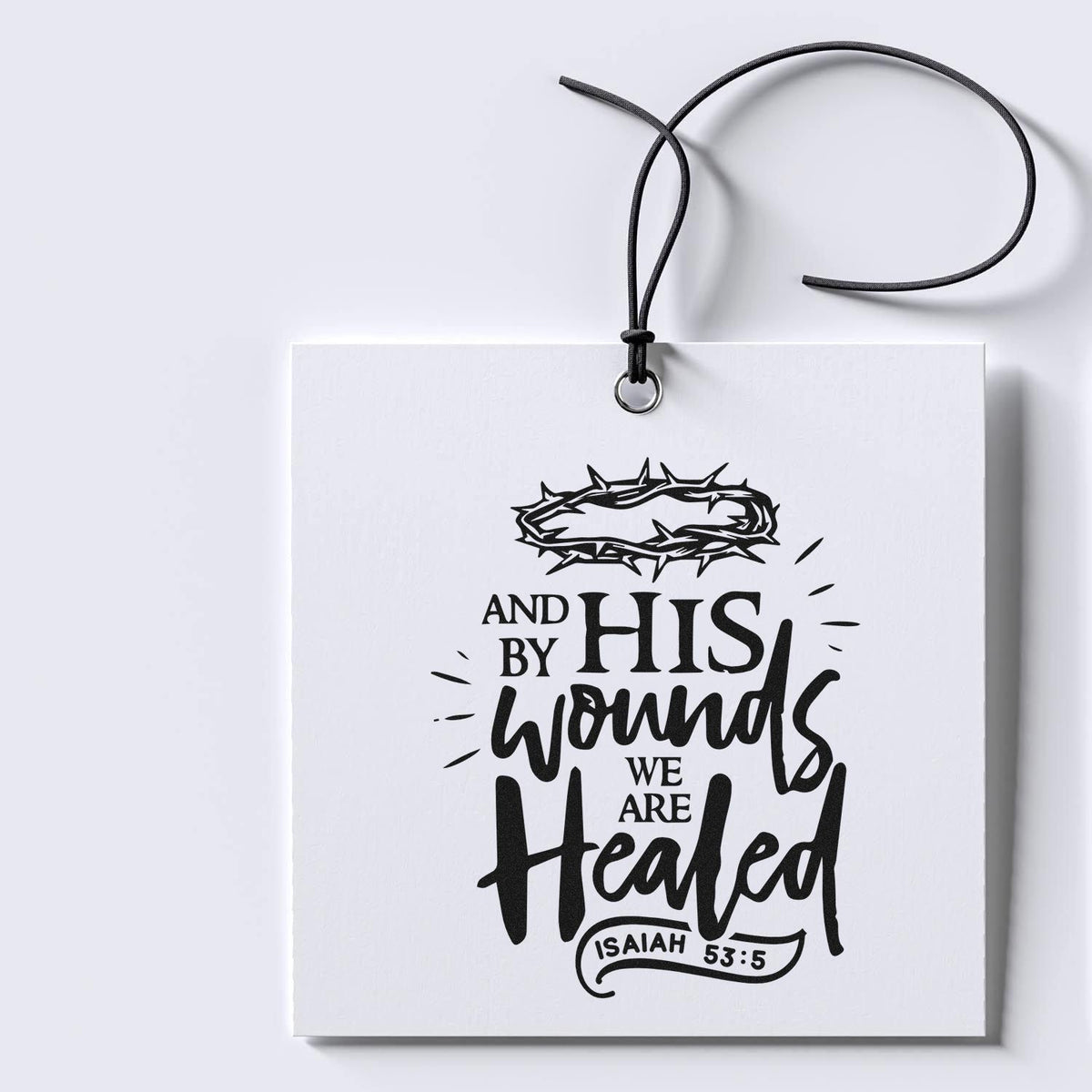 White hanging stamp and seal tag with black Christian quote, thorn crown graphic, and Isaiah 53:5 lettering.