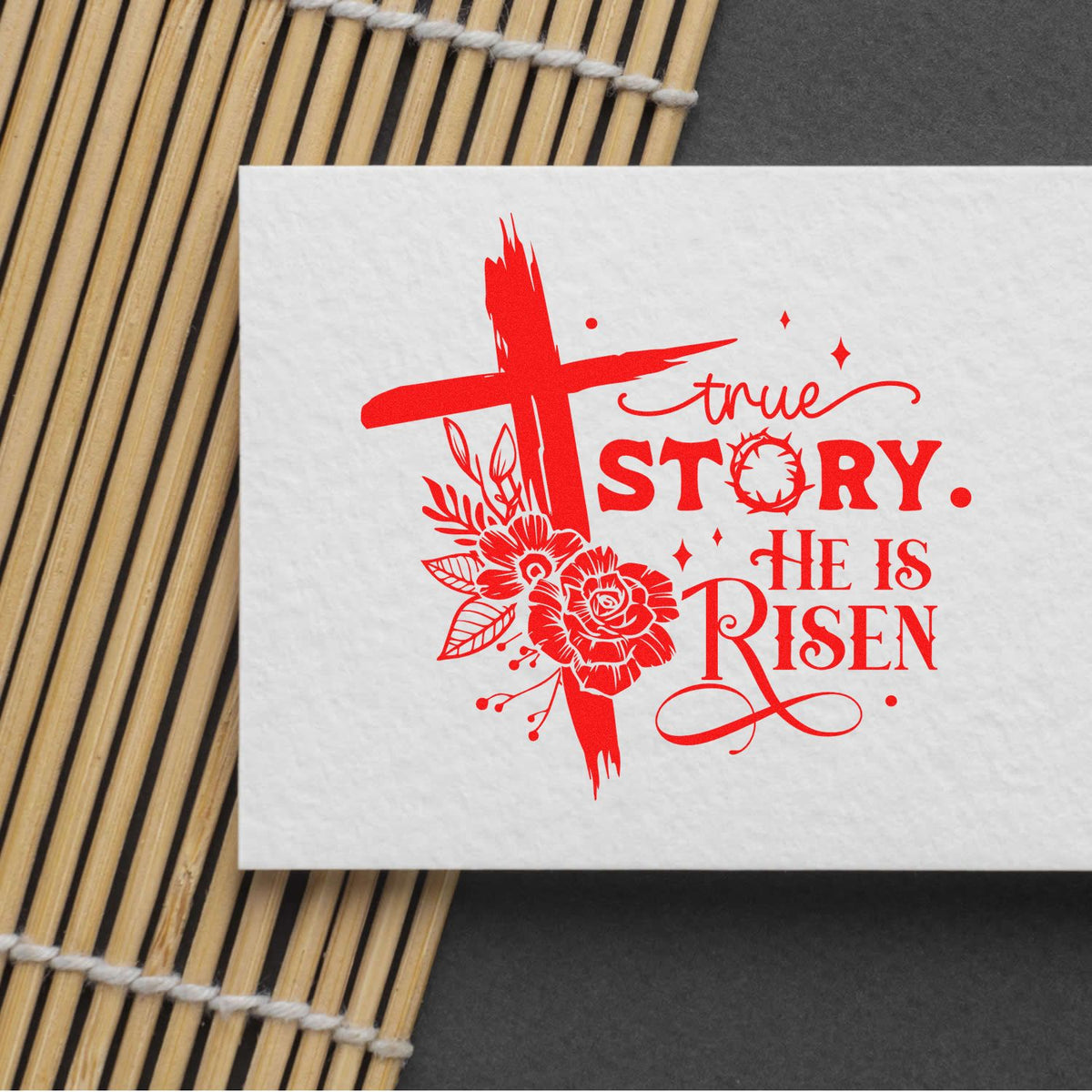 Red Christian stamp and seal design with cross, flowers, and True Story, He Is Risen on white paper.
