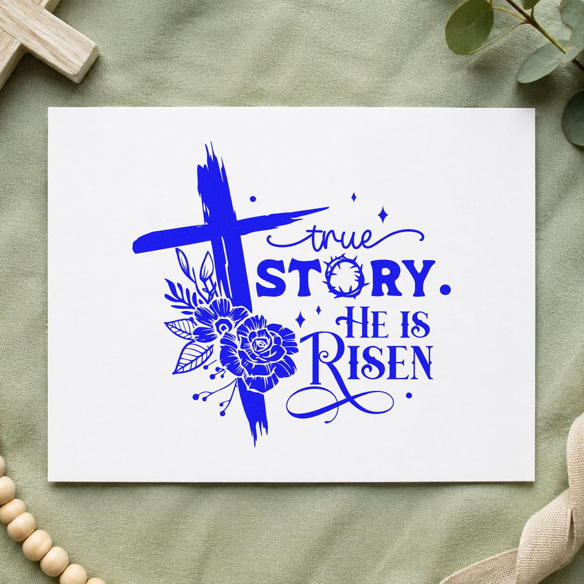 True Story He Is Risen Floral craft stamp imprinted in blue ink on paper, a design suited to spring tote bags.