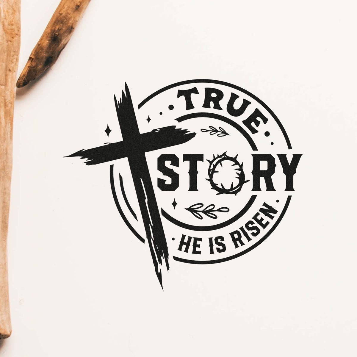 Black religious stamp seal with cross and TRUE STORY HE IS RISEN text on white, with wooden stamping tools at left.