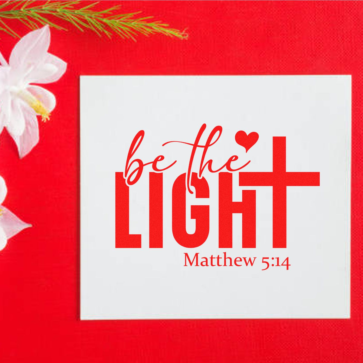 Red stamp and seal design with be the light Matthew 5:14 on a white square, with floral accents.