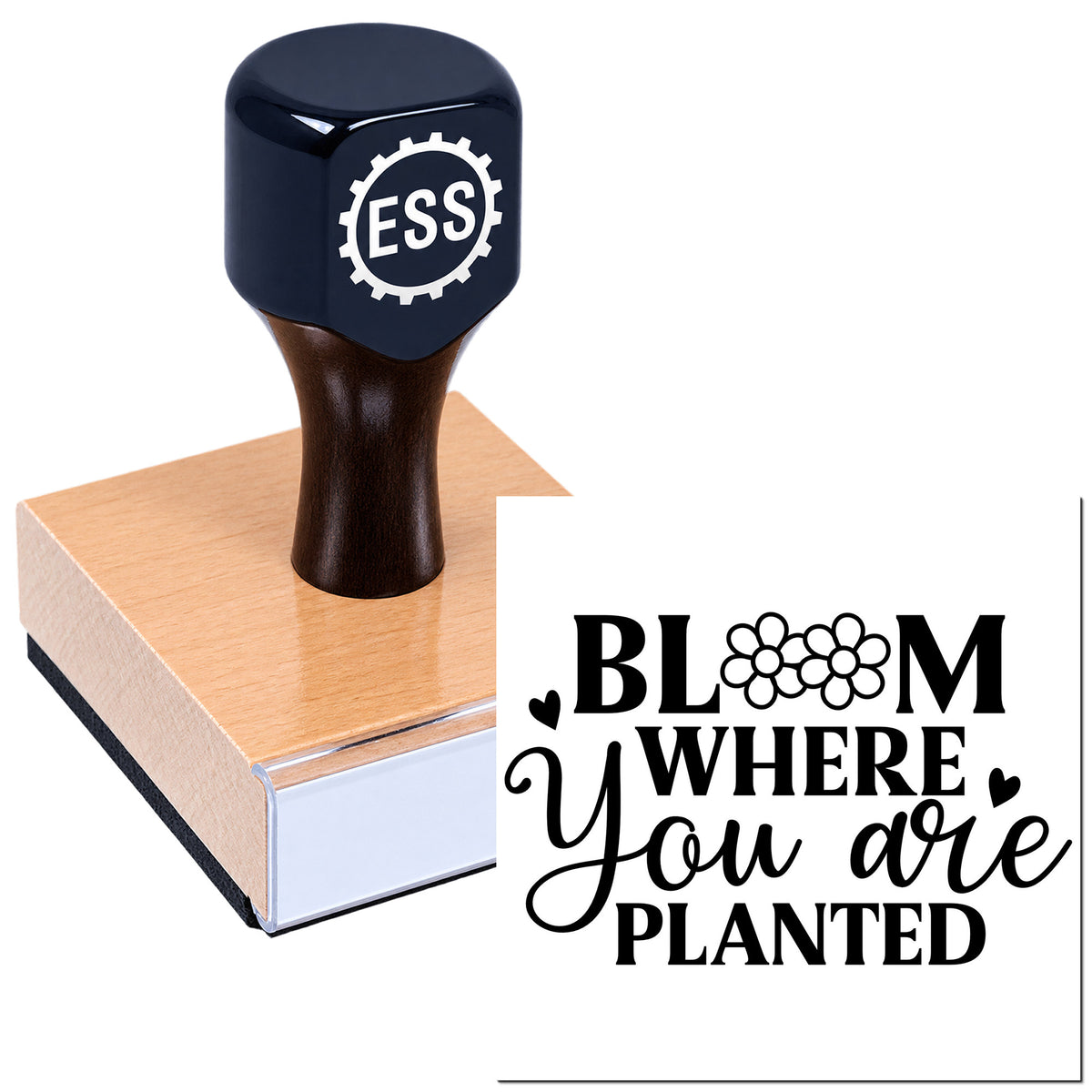 Black ESS rubber stamp on a wooden block, showing a floral "Bloom where you are planted" seal design.