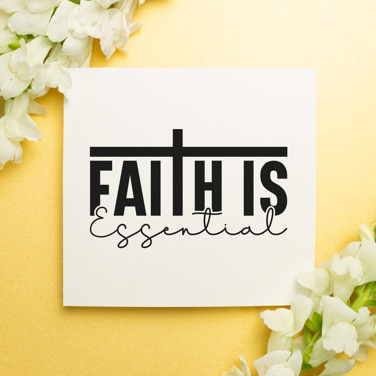 Black Faith is Essential stamp and seal on a white card, framed by white flowers on a soft yellow background.