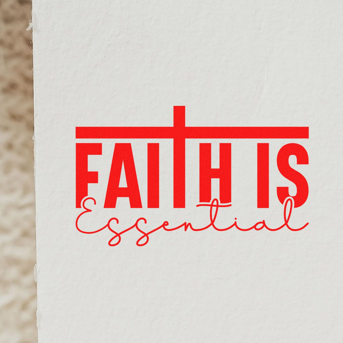 Red Faith Is Essential stamp and seal design on white textured paper