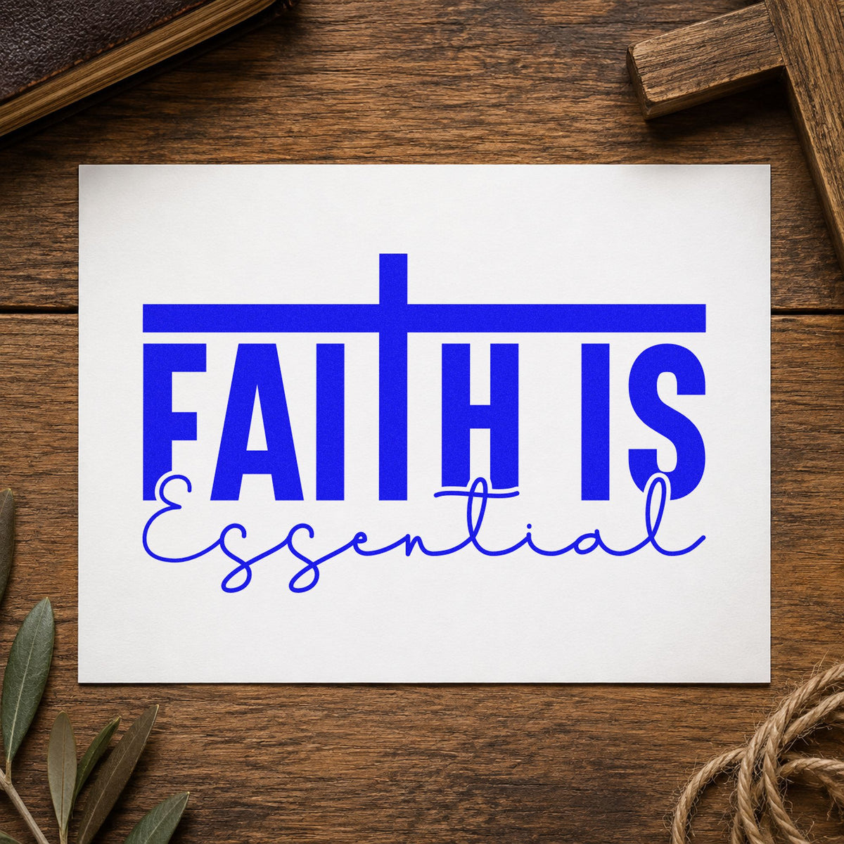 Faith Is Essential craft stamp imprinted in blue ink on paper, a design suited to kraft gift bags.