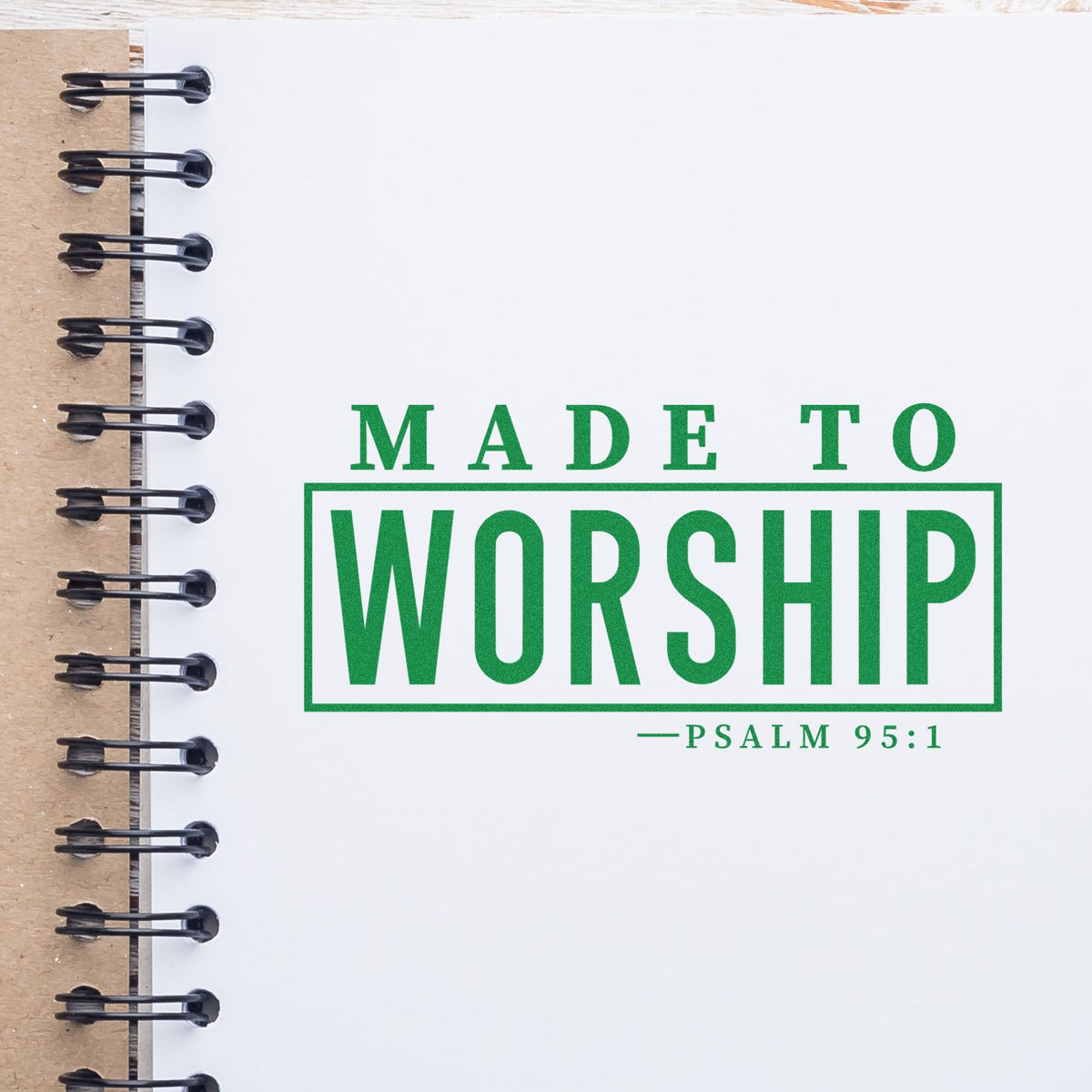 Green MADE TO WORSHIP Psalm 95:1 stamp seal on a white notebook page with black spiral binding and kraft cover.
