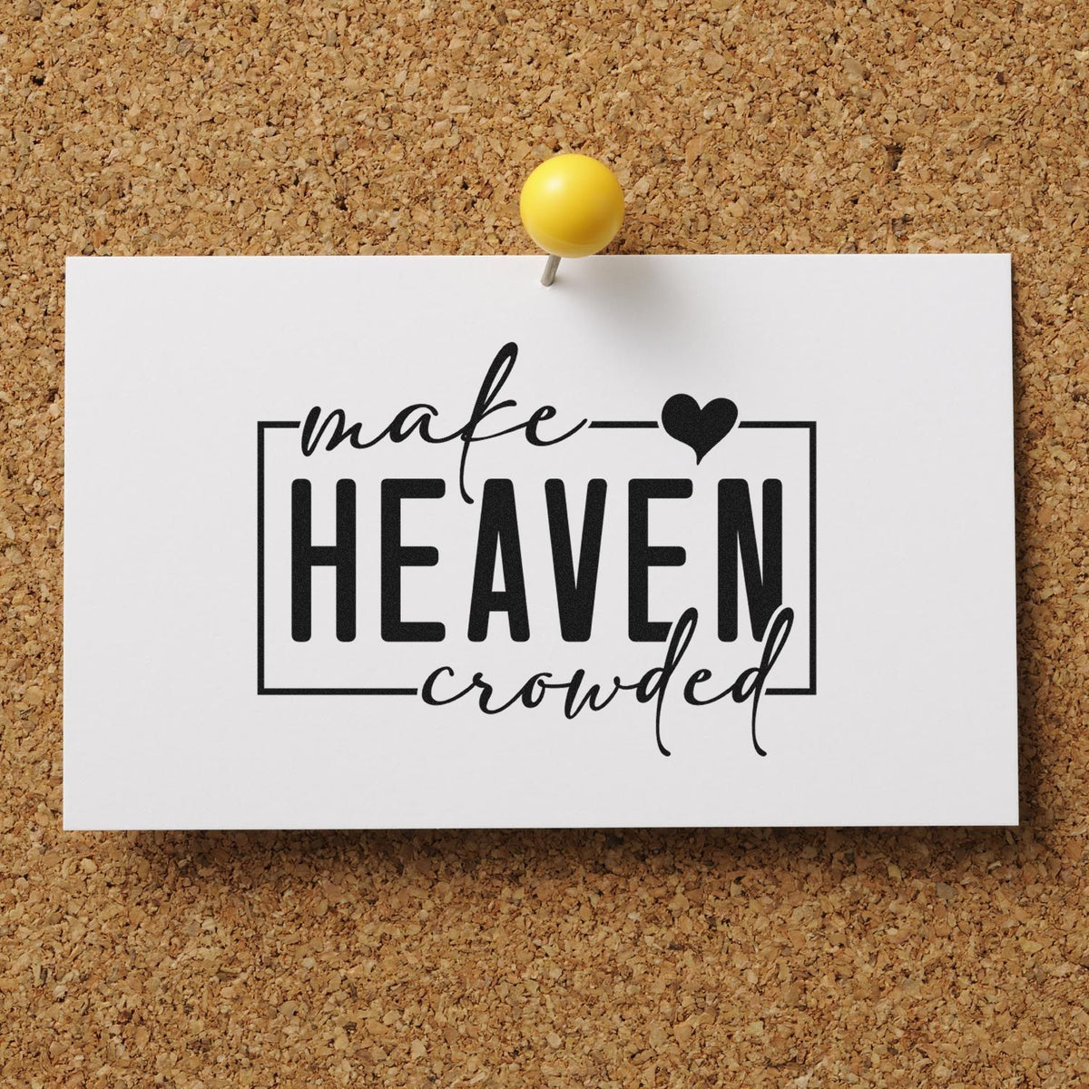 Black make heaven crowded stamp and seal design on white card, pinned to corkboard with a yellow pushpin.