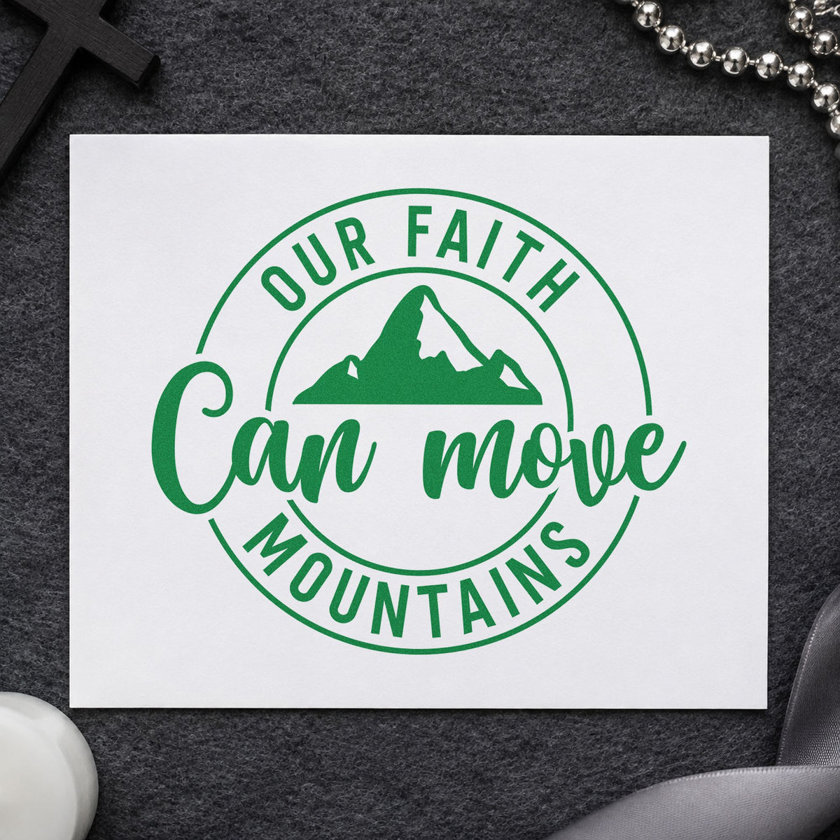 Faith Can Move Mountains craft stamp imprint in green ink on a handmade project, one idea being camp name tags.