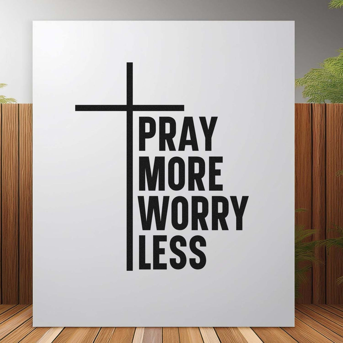 Black stamp and seal design with cross and bold Pray More Worry Less text on a white background.