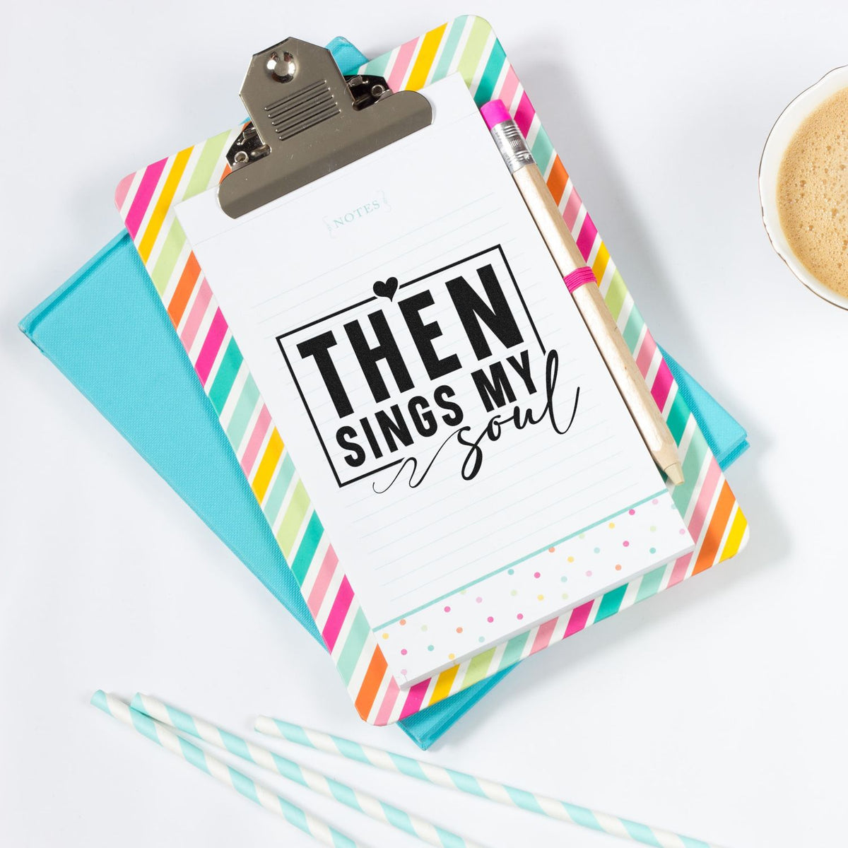 Colorful stamp and seal stationery set with striped clipboard, bold Then sings my soul print, pencil, and coffee cup.