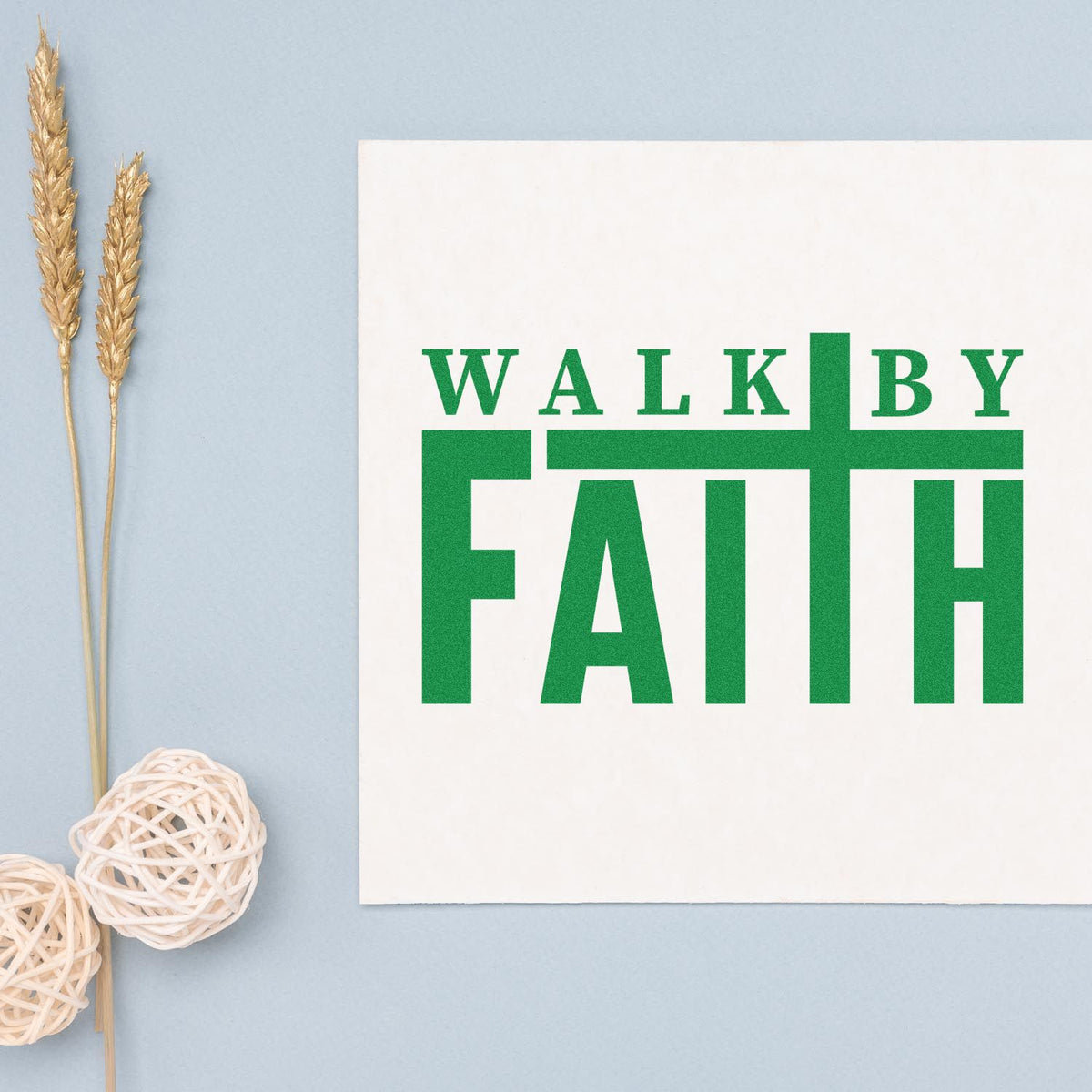 Green WALK BY FAITH stamp and seal on white card, with light blue background, gold wheat stems, and white woven decor.