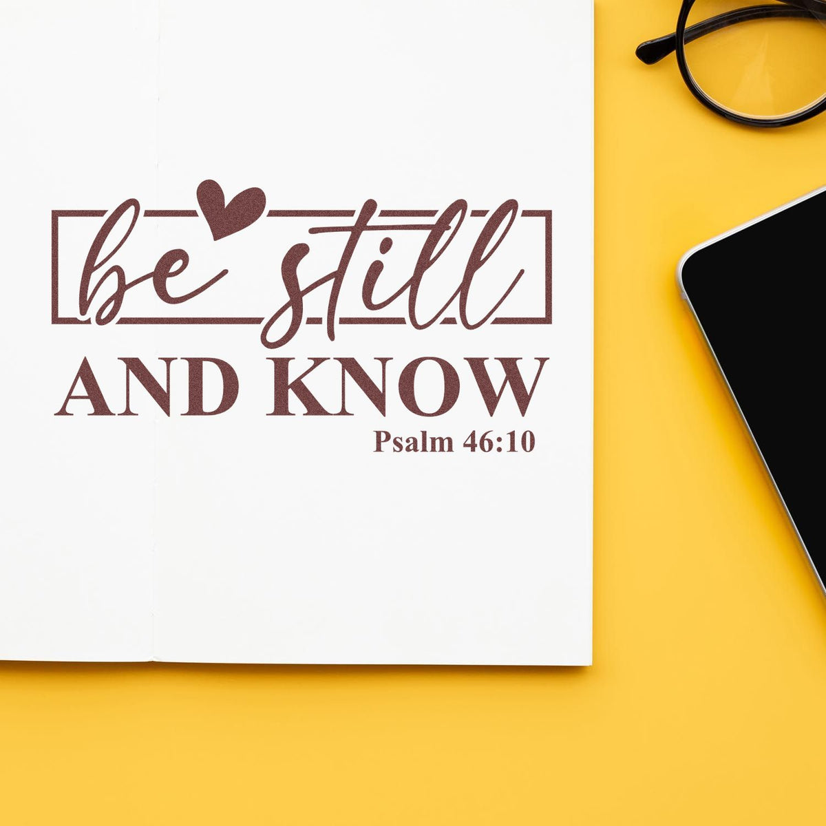 Brown be still and know Psalm 46:10 stamp and seal design with heart on white paper, yellow background.