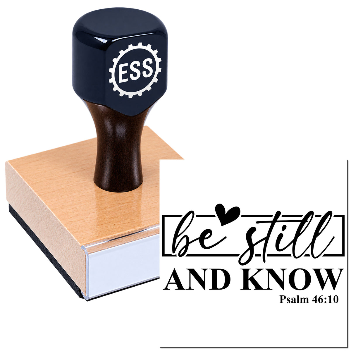 Black ESS stamp seal on a wooden base with a white "be still and know" Psalm 46:10 design.