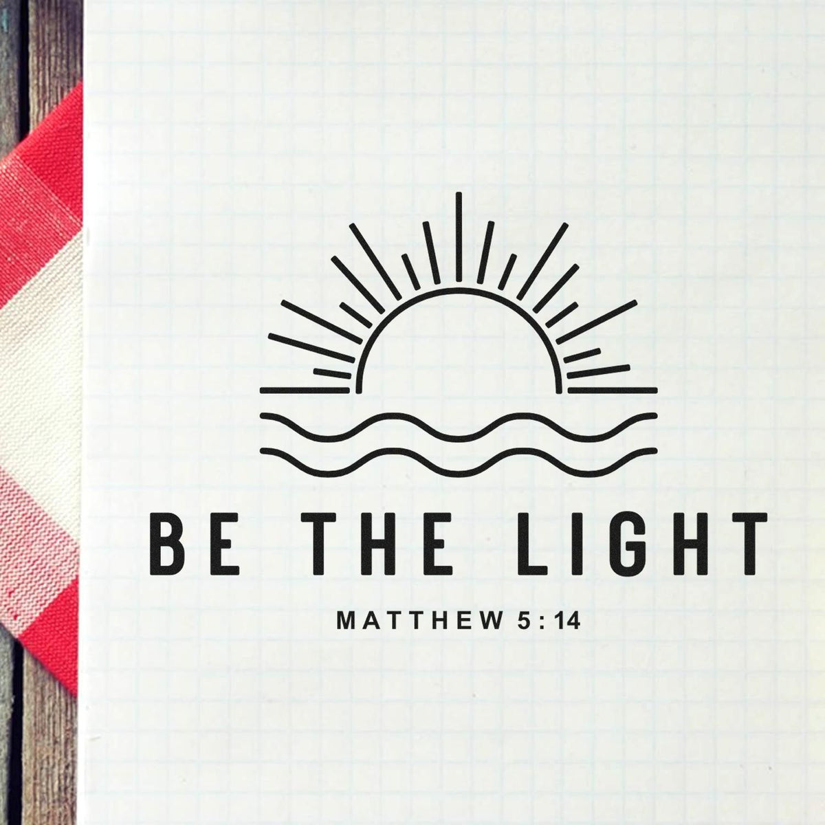 Black stamp and seal design with sun rays and waves reading Be the Light Matthew 5:14 on light grid paper.