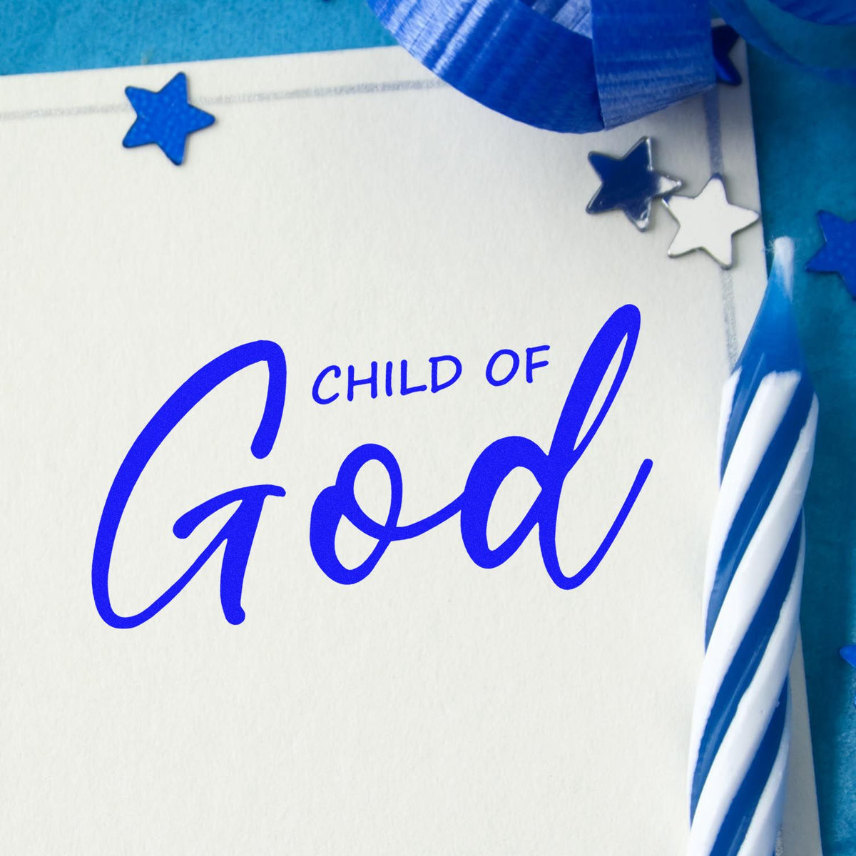 Blue Child of God stamp with star seals on white card, accented by a blue ribbon.