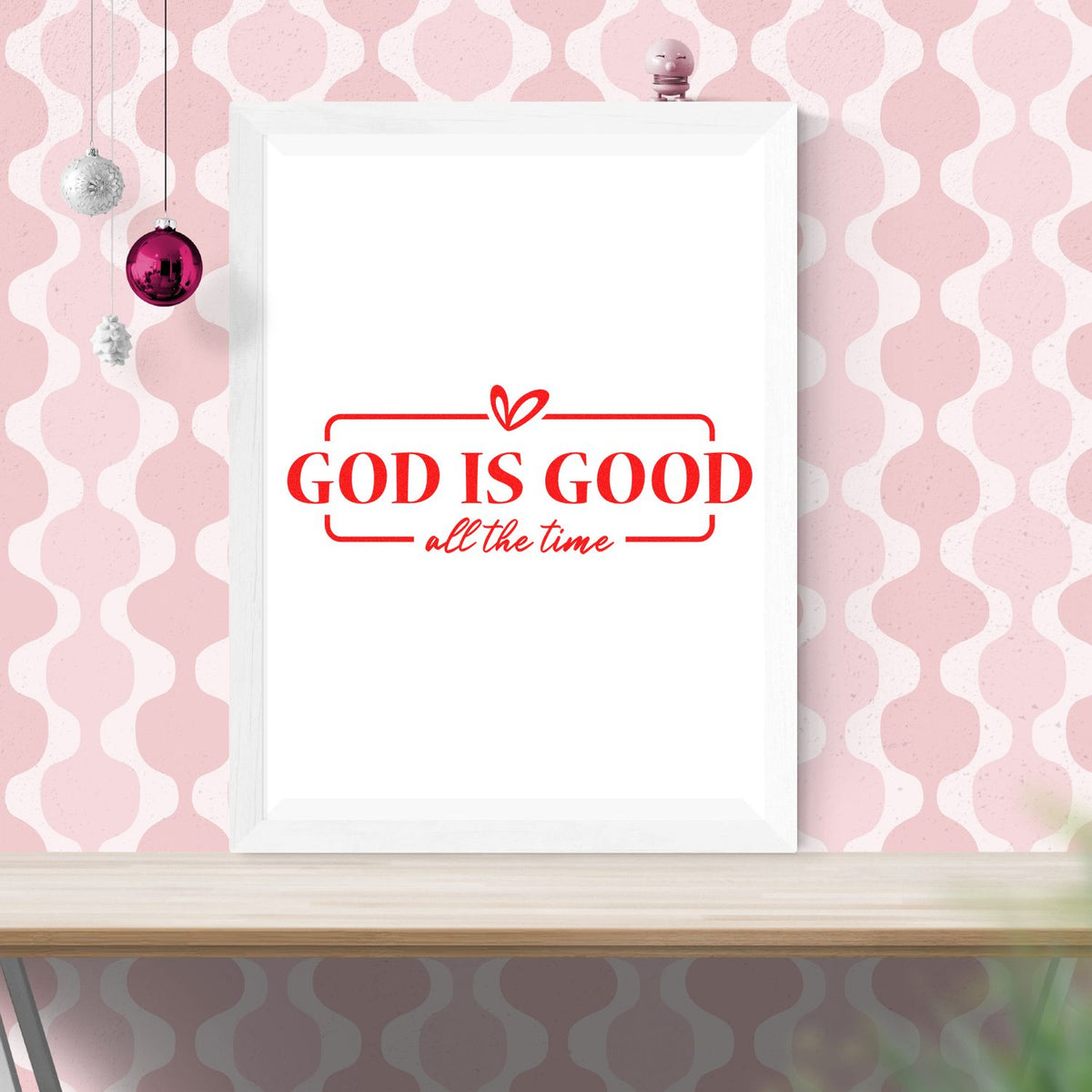 Red God Is Good all the time faith stamp/seal design on a white framed print against a pink patterned background.