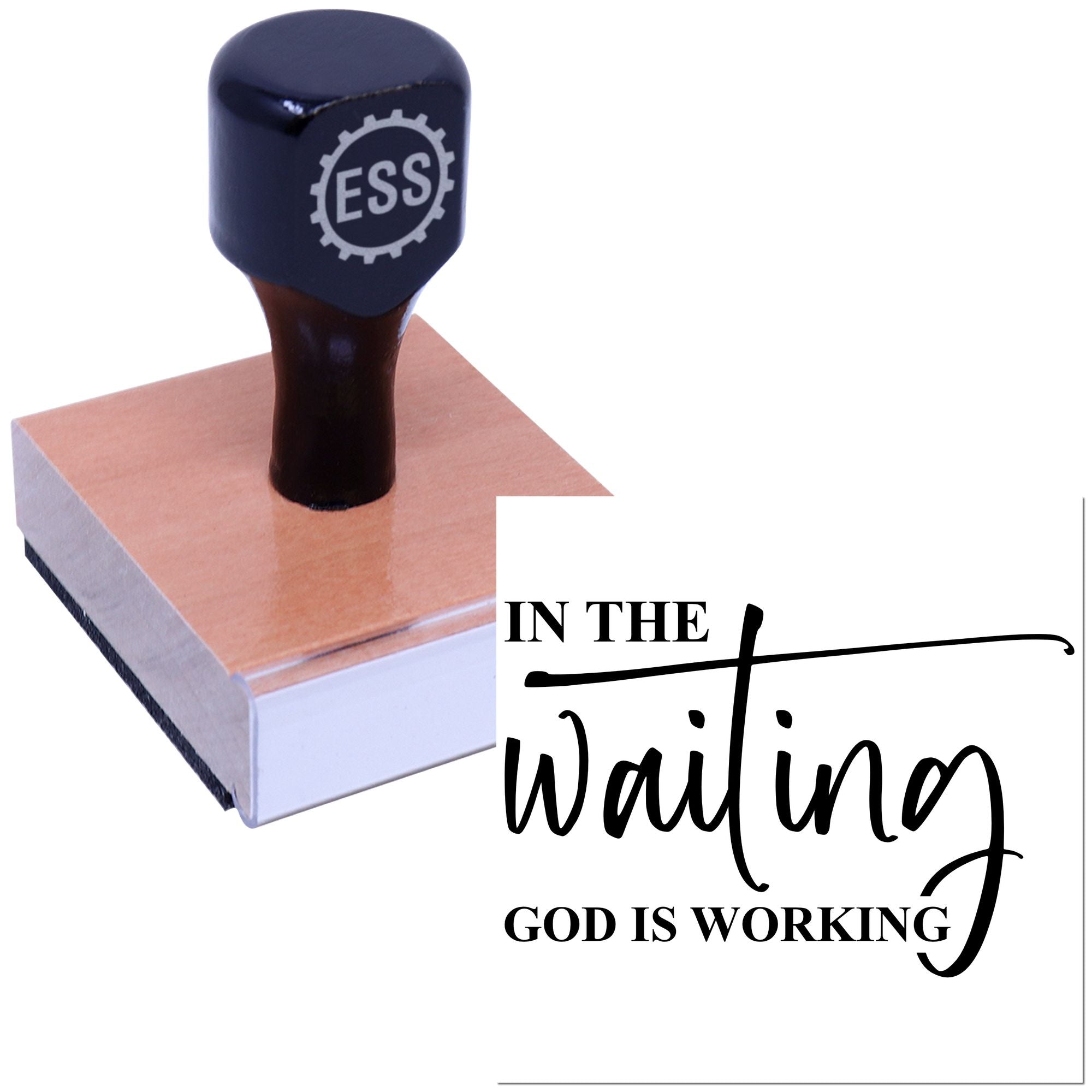 Black ESS stamp and seal on a wooden block with In the Waiting God is Working lettering.