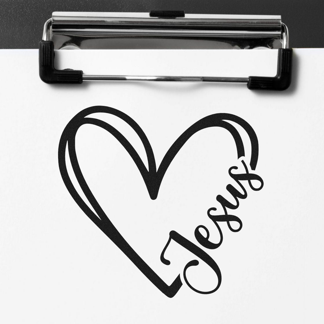 Black heart-shaped stamp with happy script on white paper under a chrome clipboard, for custom stamp and seal products.