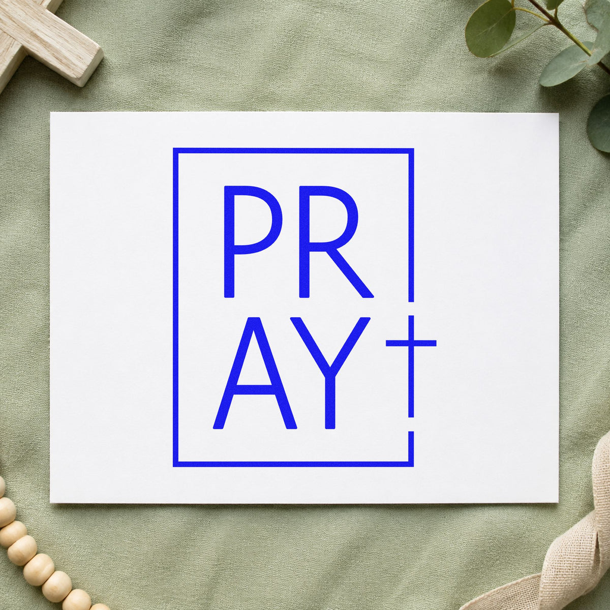 Pray Minimal Cross craft stamp in blue ink on cardstock, an easy option for tee transfers.