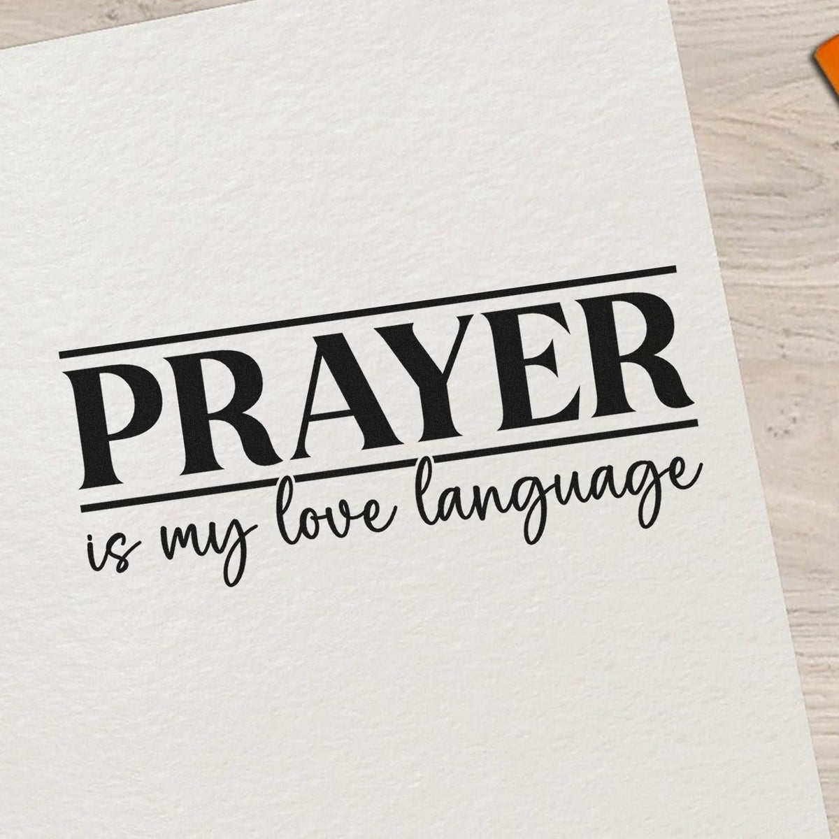 Black custom stamp seal reading PRAYER is my love language on white paper, with bold serif and script lettering.