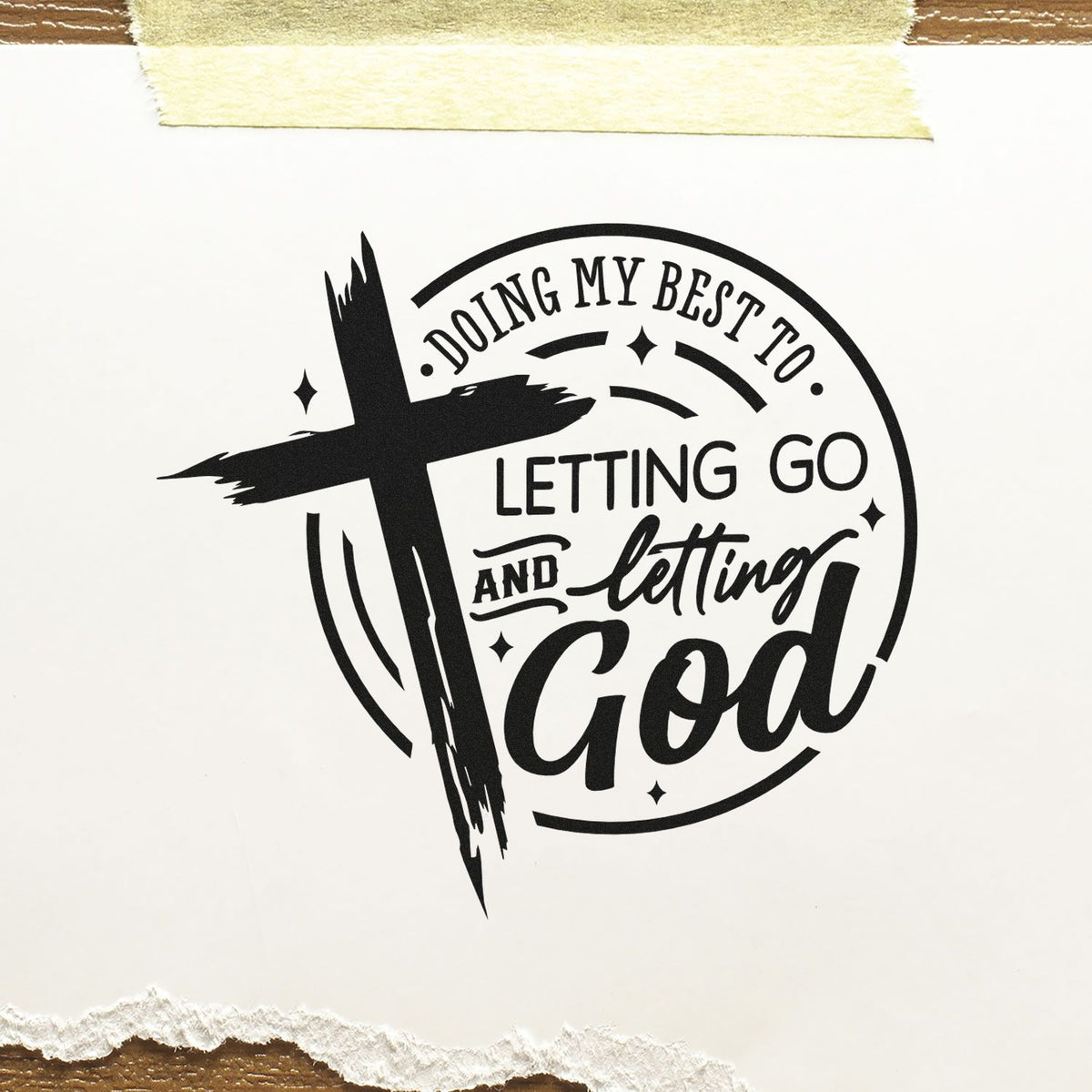 Black circular faith stamp seal with cross and text Doing my best to let go and letting God on white paper.