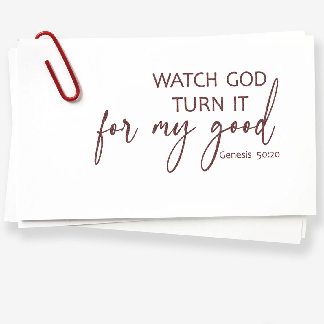 White stamp and seal cards with burgundy Watch God turn it for my good Genesis 50:20 text and a red paperclip.
