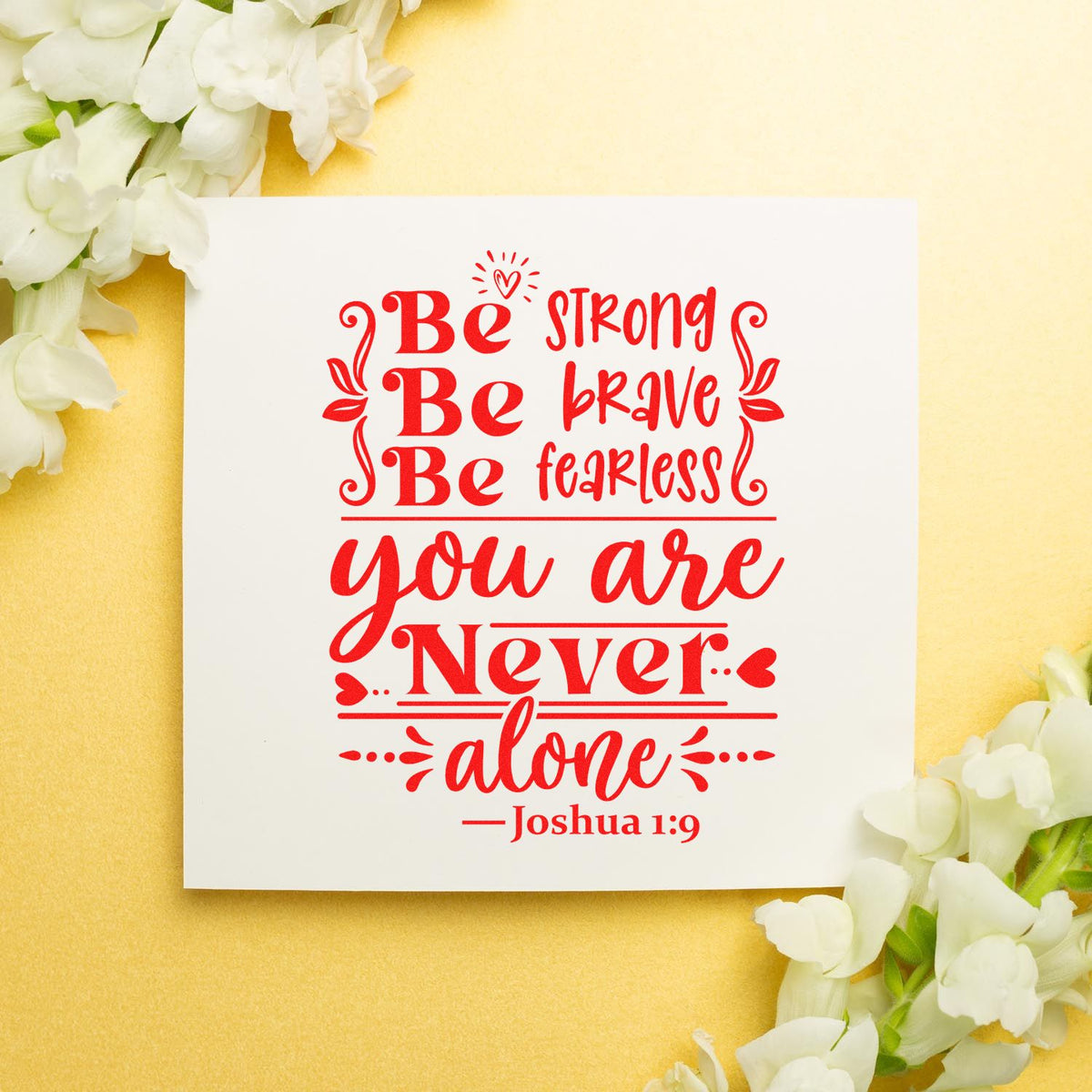 Red stamp and seal design on white card with yellow background and white flowers, reading Be strong, be brave, be fearless, you are never alone.