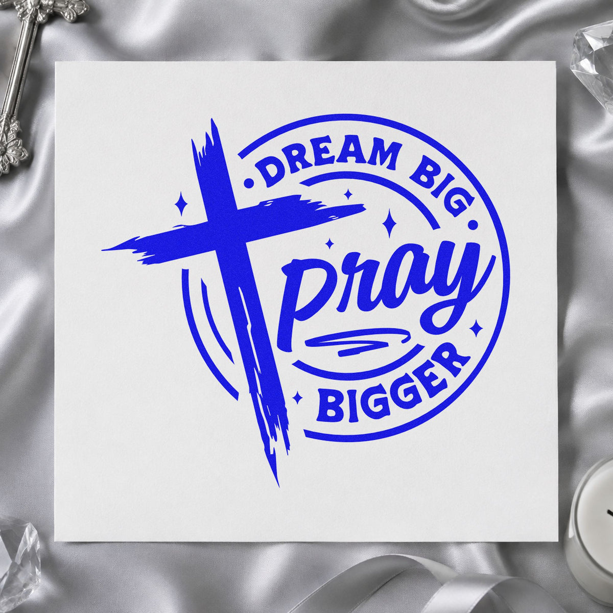 Dream Big Pray Bigger craft stamp imprinted in blue ink on paper, a design suited to canvas totes.