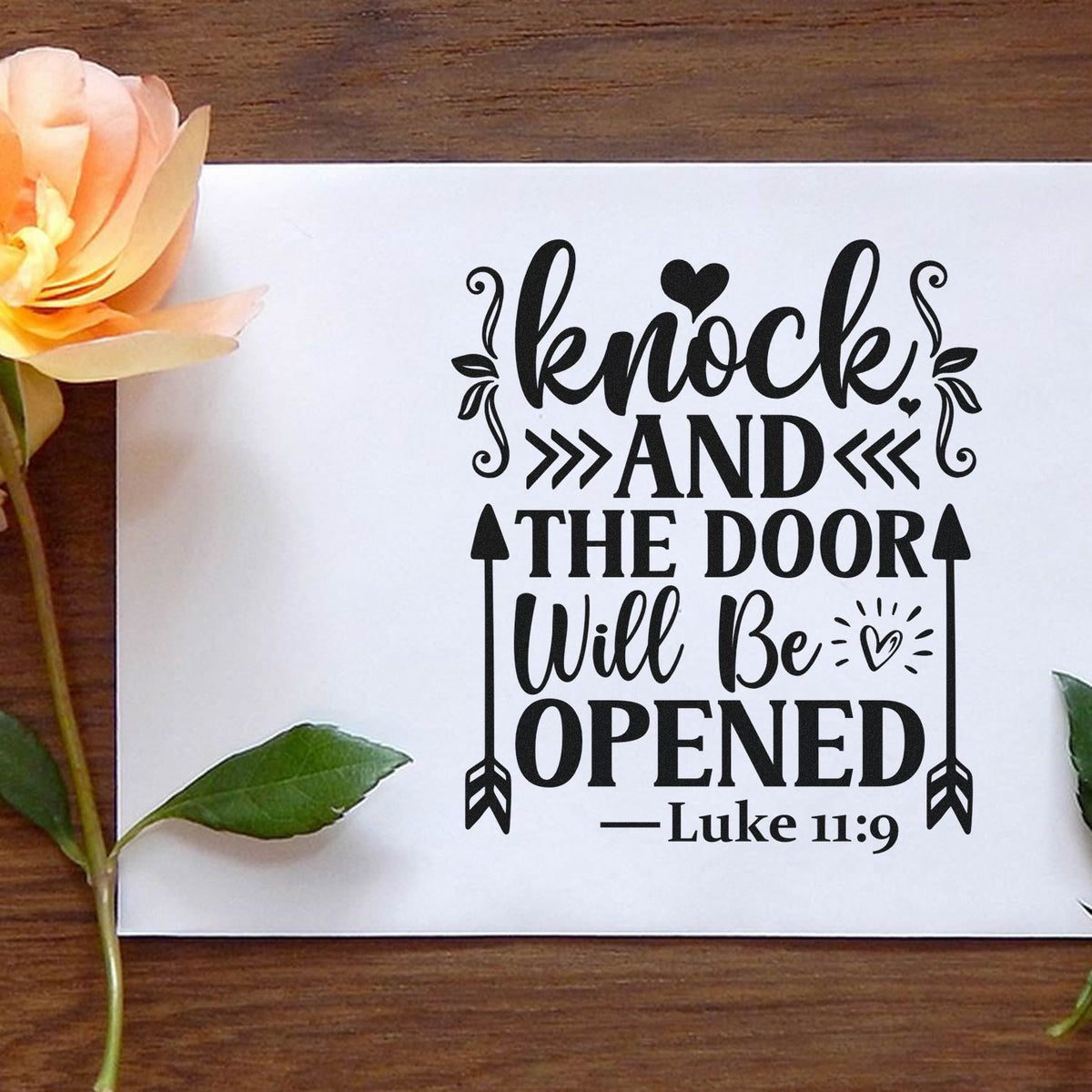 Black decorative stamp and seal design reading Knock and the door will be opened on white card, with peach flower and green leaves.