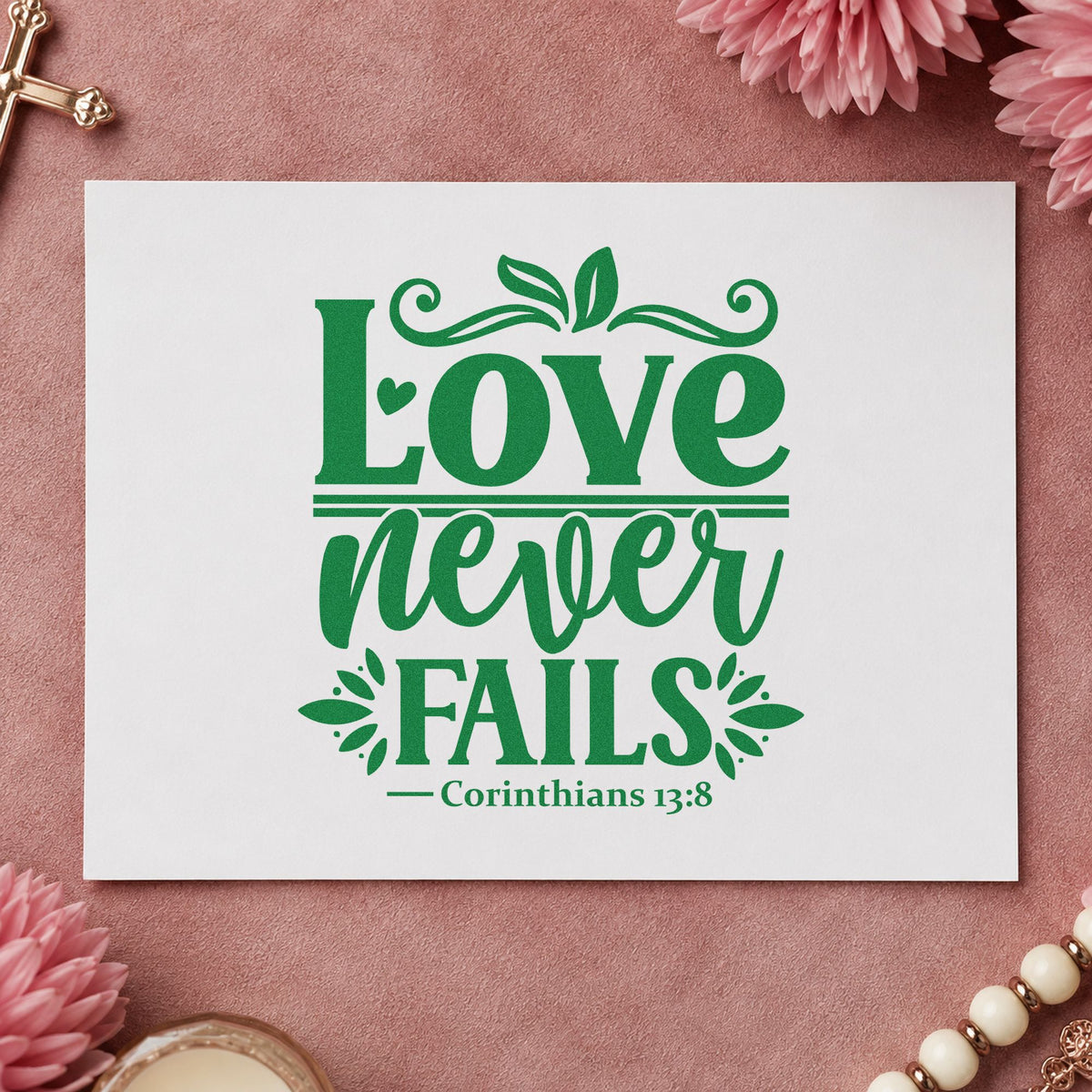 Love Never Fails craft stamp imprint in green ink on a handmade project, one idea being anniversary gifts.