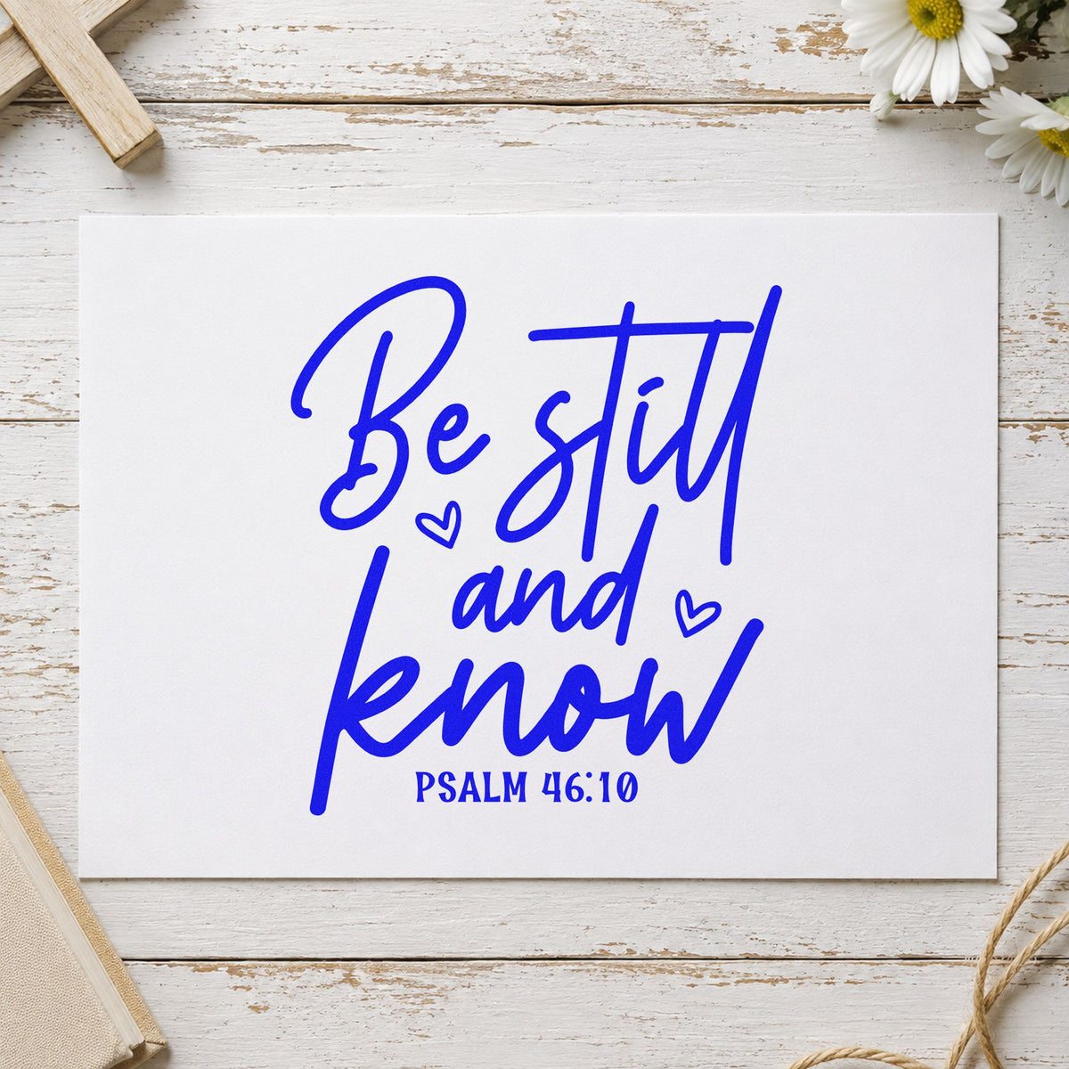 Be Still and Know Script craft stamp imprinted in blue ink on paper, a design suited to chaplain cards.