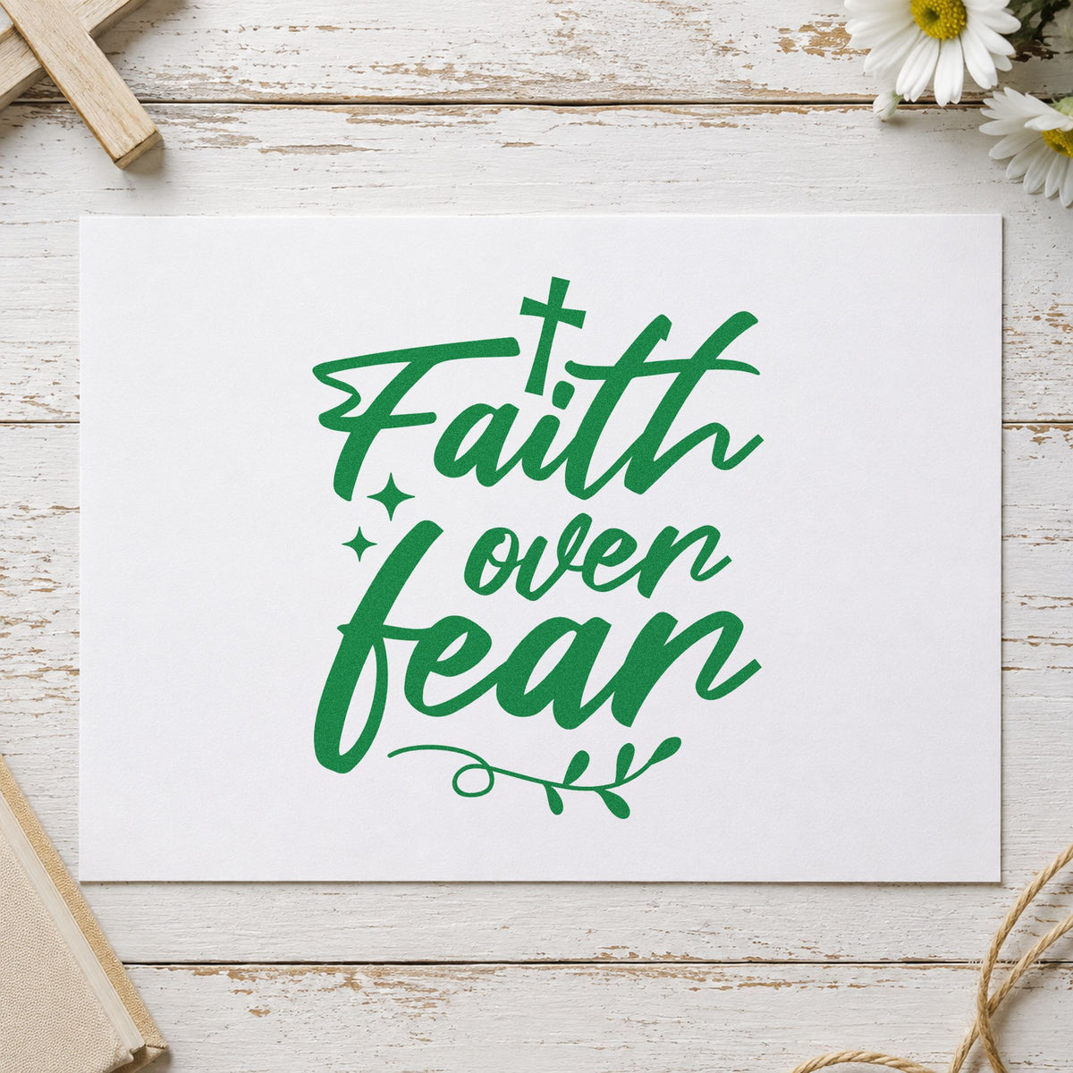 Faith over Fear Flourish craft stamp imprint in green ink on a handmade project, one idea being framed bedroom art.