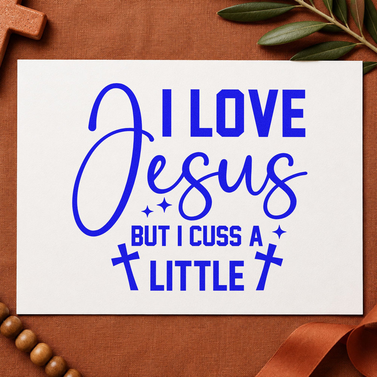 I Love Jesus but Cuss craft stamp in blue ink on cardstock, an easy option for canvas totes.