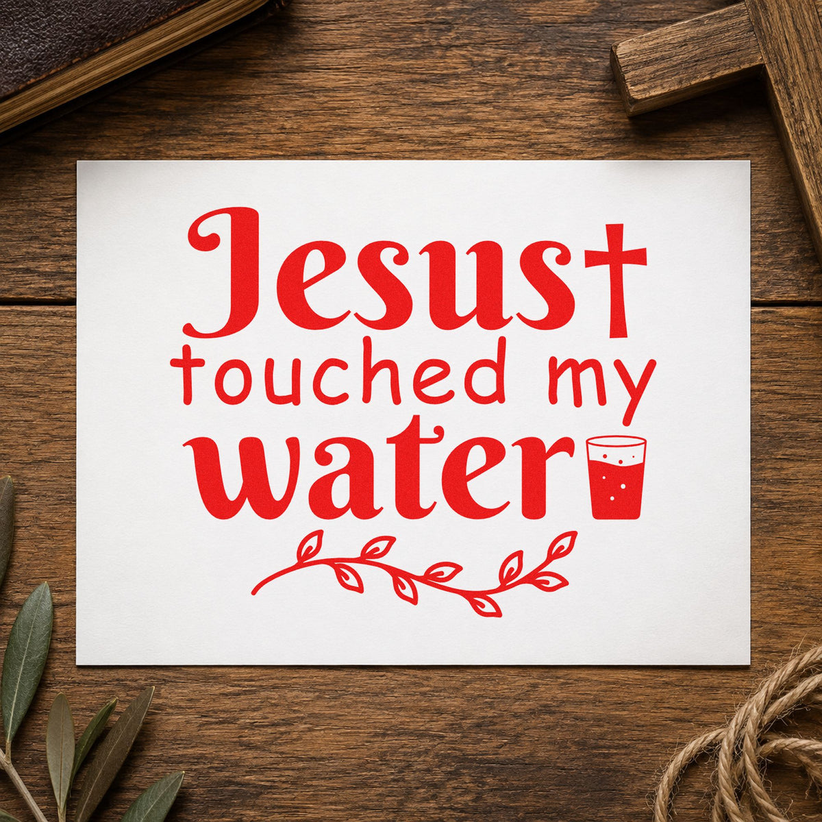 Jesus Touched My Water rubber stamp shown in red ink, stamped for projects such as glass charm labels.