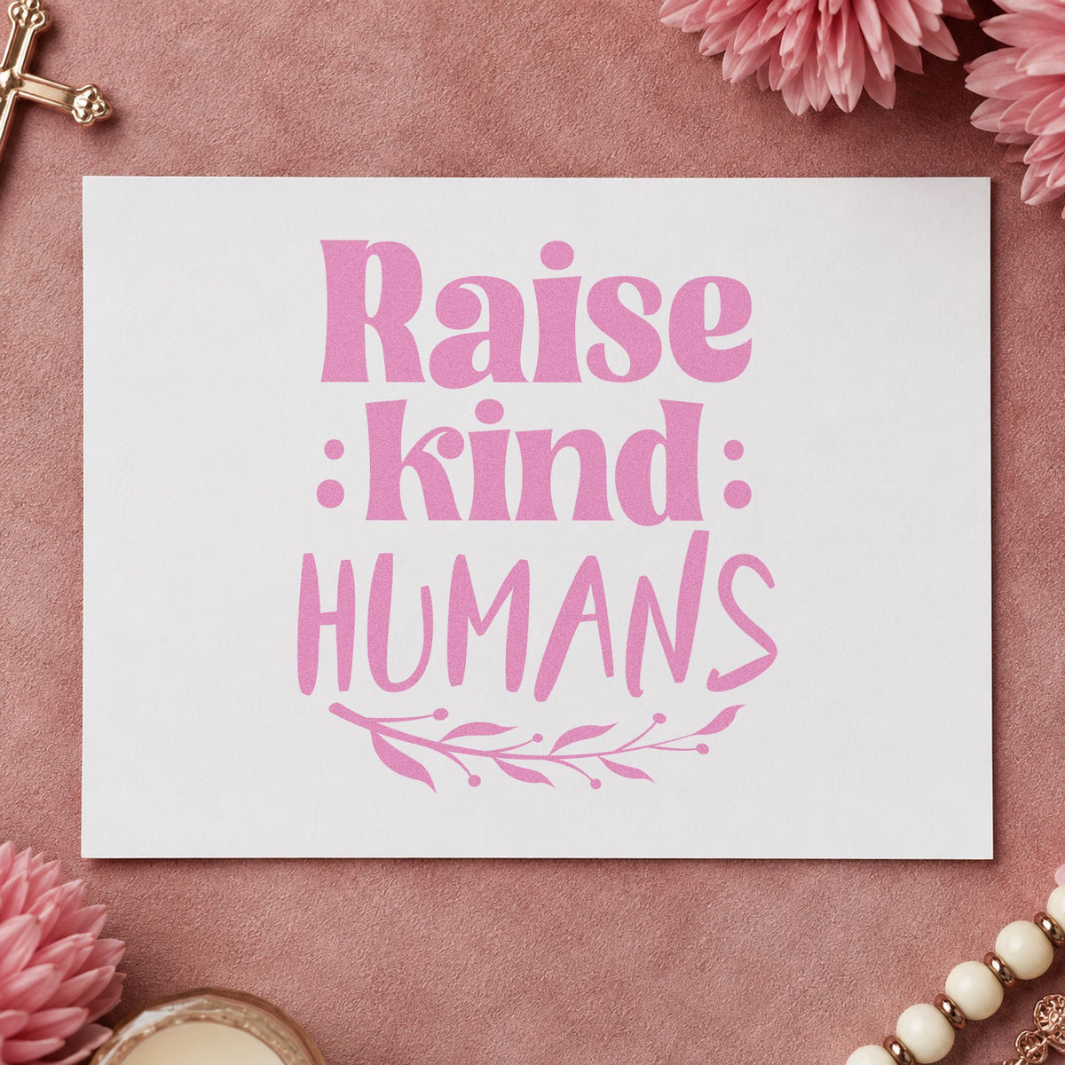 Raise Kind Humans craft stamp in purple ink on cardstock, an easy option for baby shower gifts.