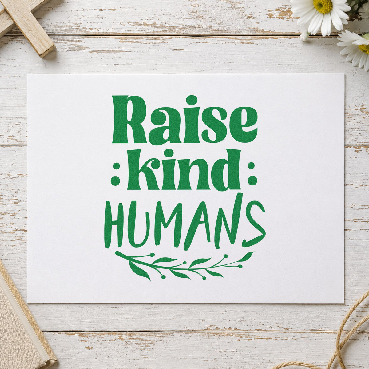 Raise Kind Humans craft stamp imprint in green ink on a handmade project, one idea being teacher gifts.