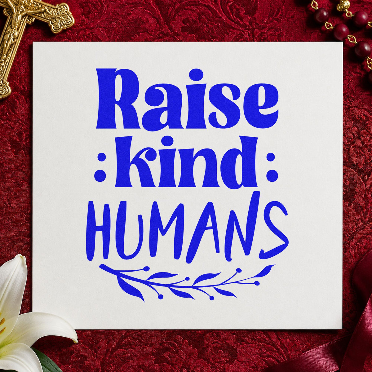 Raise Kind Humans craft stamp in blue ink on cardstock, an easy option for parent tees.