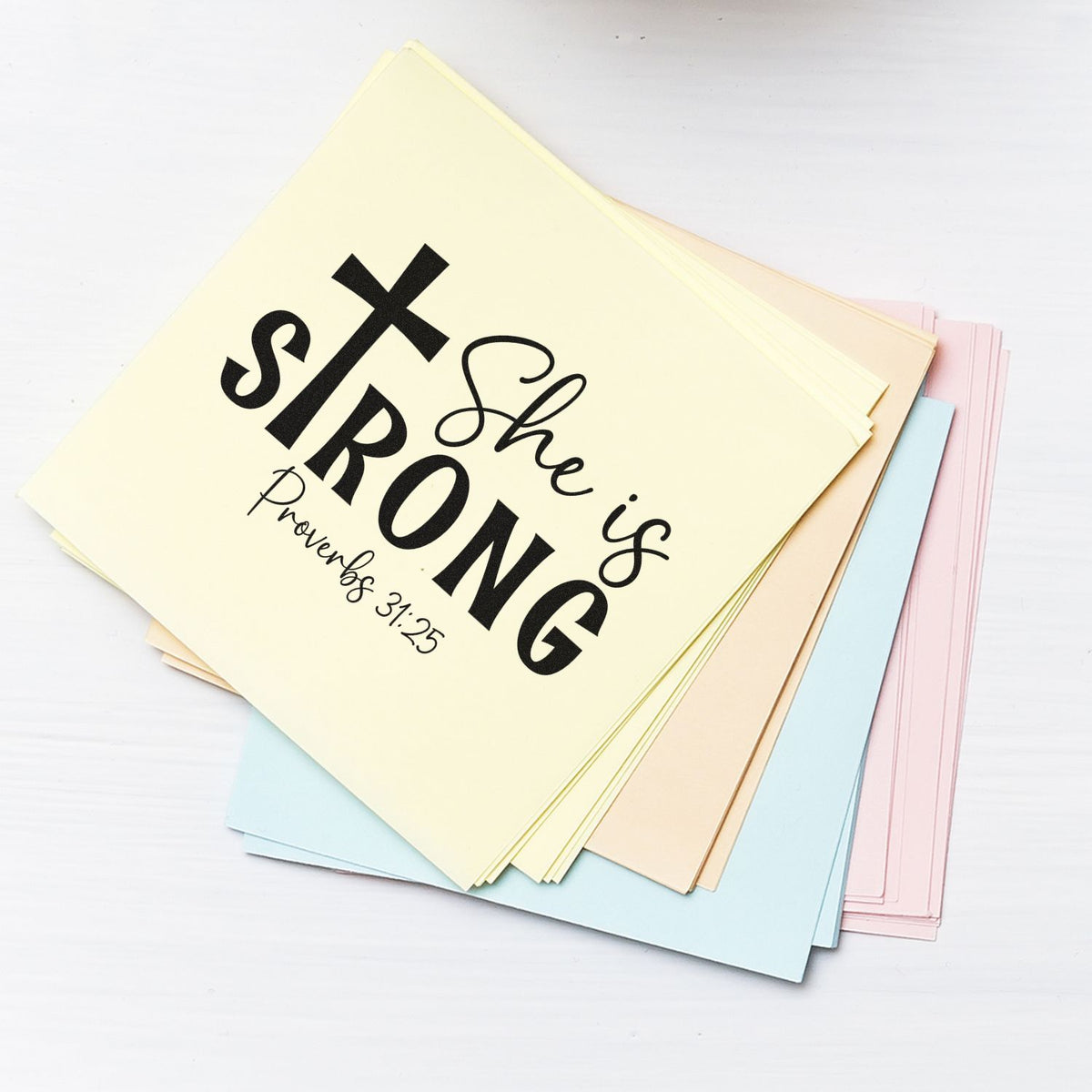 Pastel stamp and seal sheets with bold black She is Strong Proverbs 31:25 design