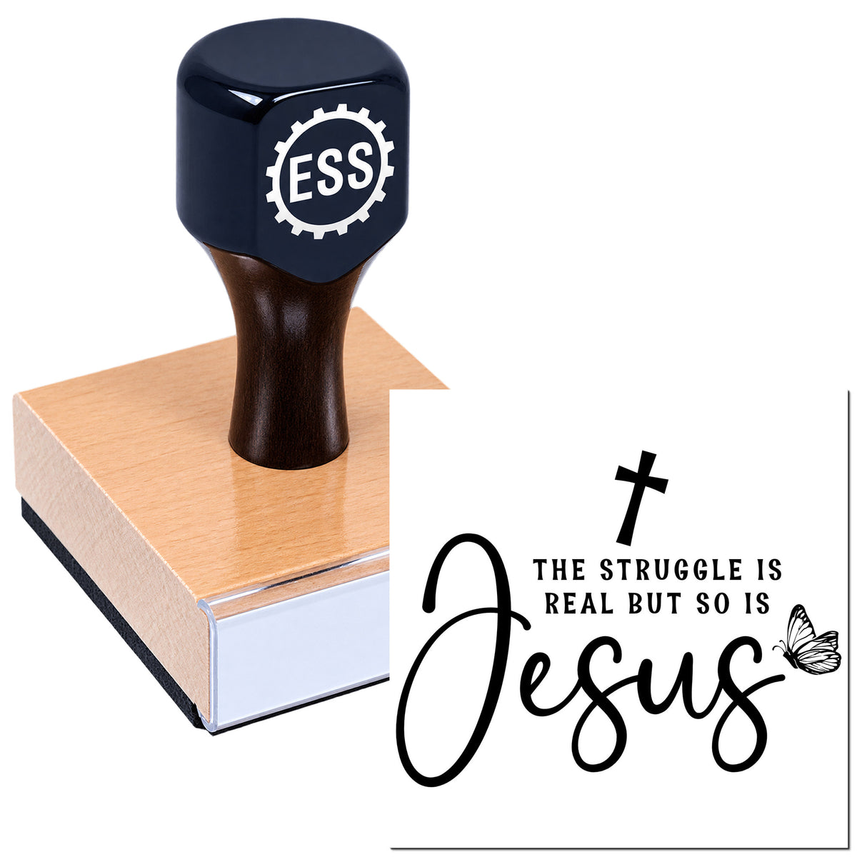 Black ESS stamp and seal on wooden block with "The struggle is real but so is Jesus" text, cross and butterfly.