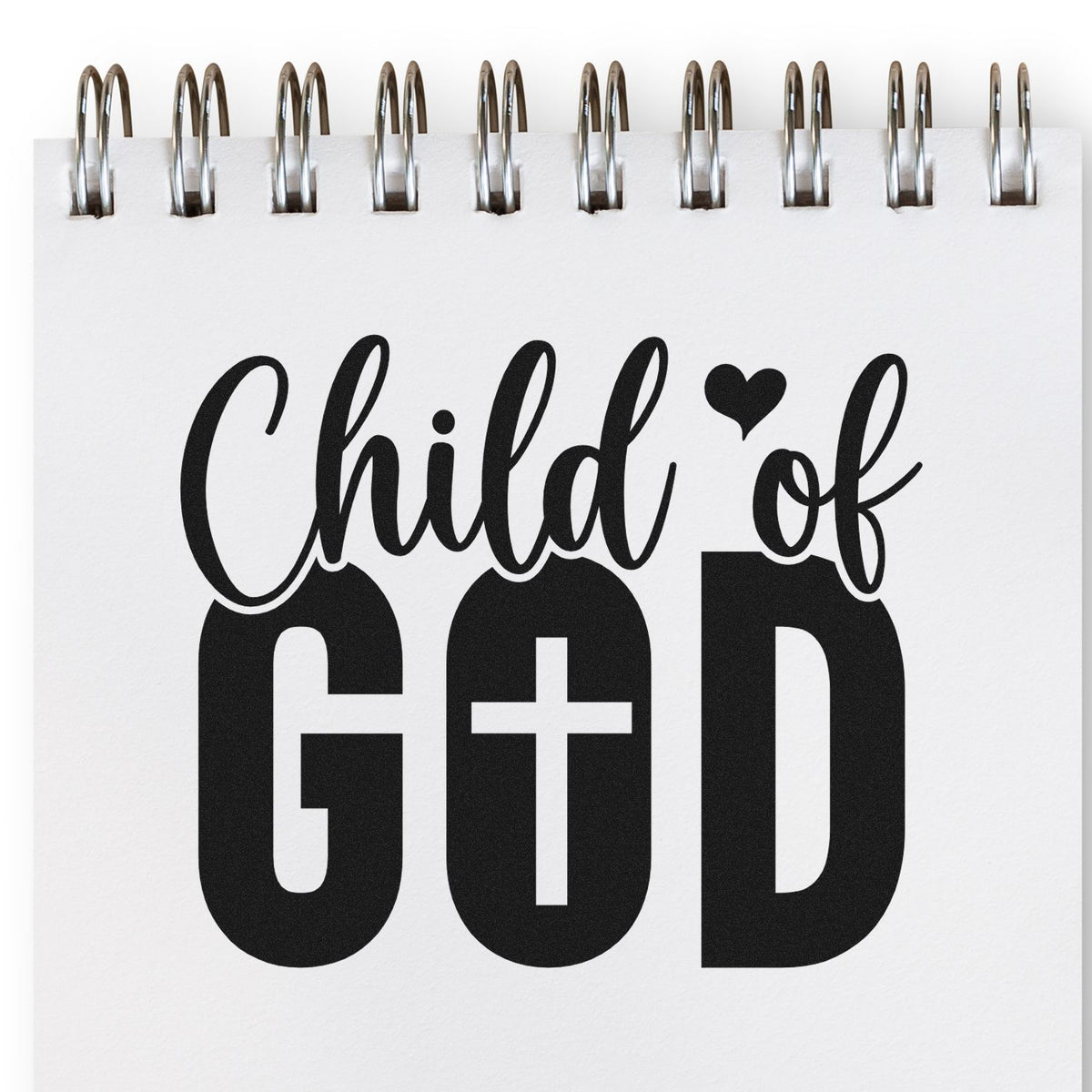 Black Child of GOD stamp and seal design on white spiral notepad, with heart and cross.