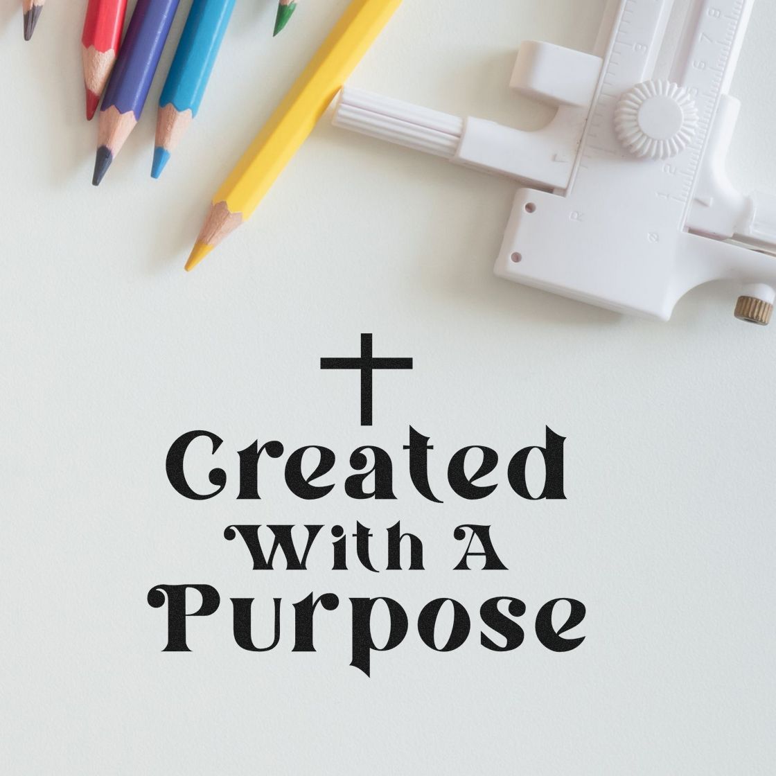 White stamp and seal tool beside colored pencils, with black Created With A Purpose design on a white background.